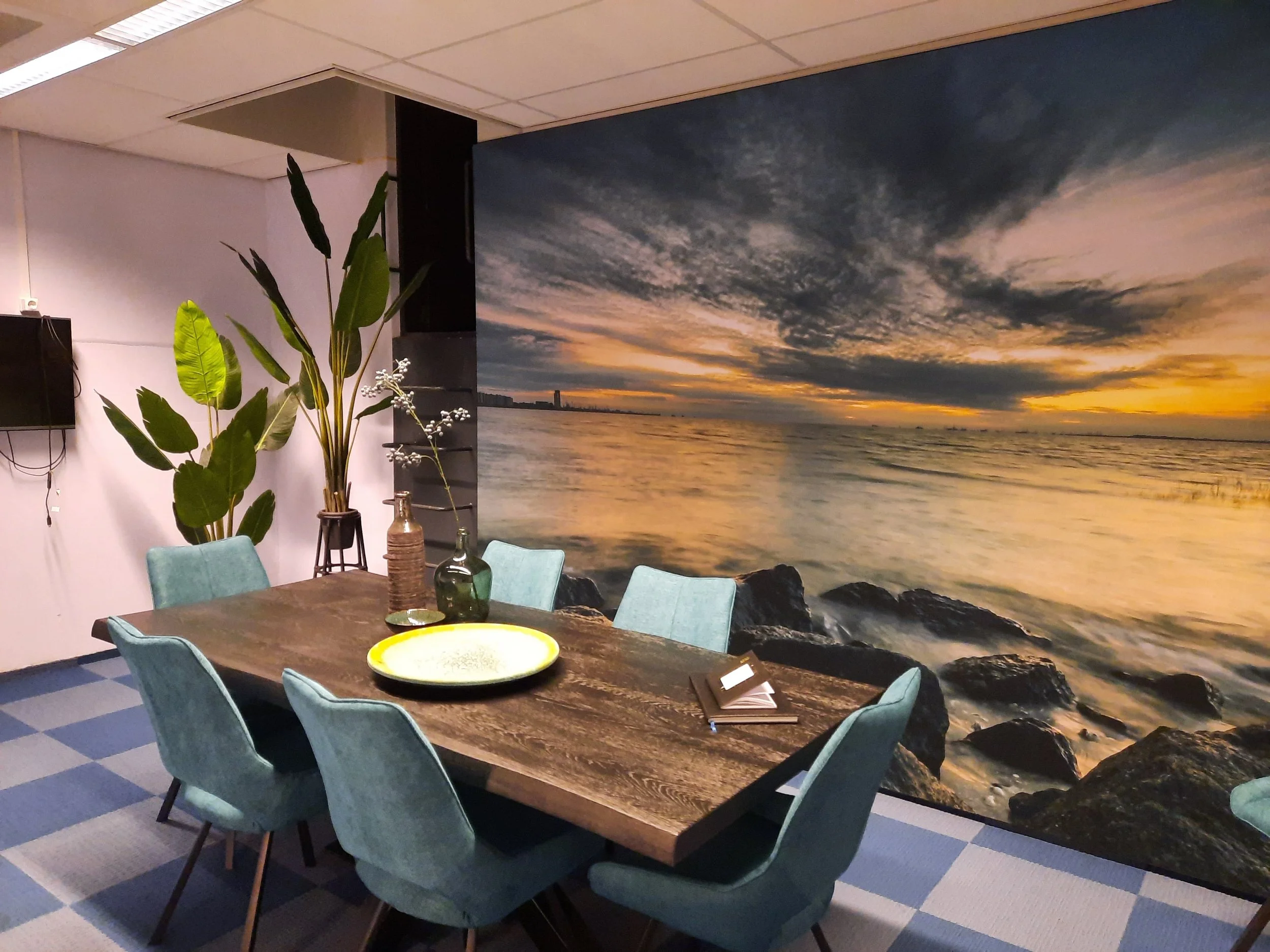 Sunset landscape wall mural wallpaper installed behind dining table in contemporary interior – Pop Papel panoramic nature seamless wallcovering completed project