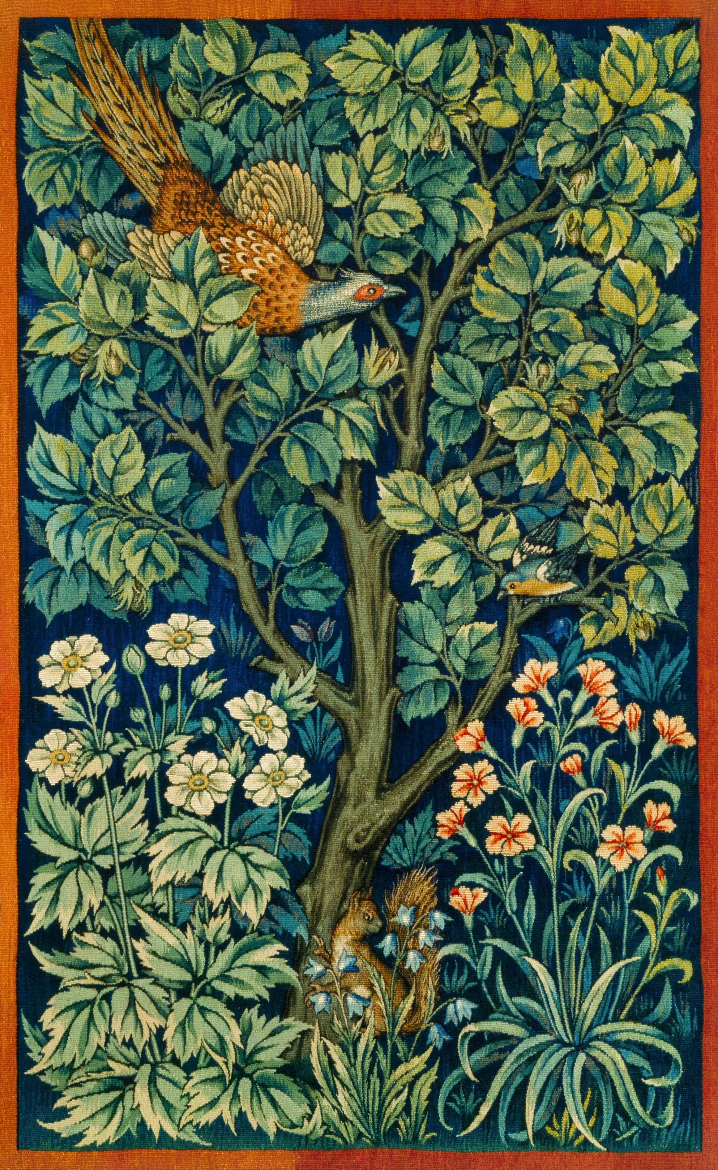 Colorful tapestry depicting a lush green tree with various birds flying among the leaves, white and orange flowers, and a squirrel at the base of the tree.