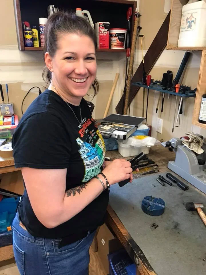 AJ looking happy cleaning gun.webp
