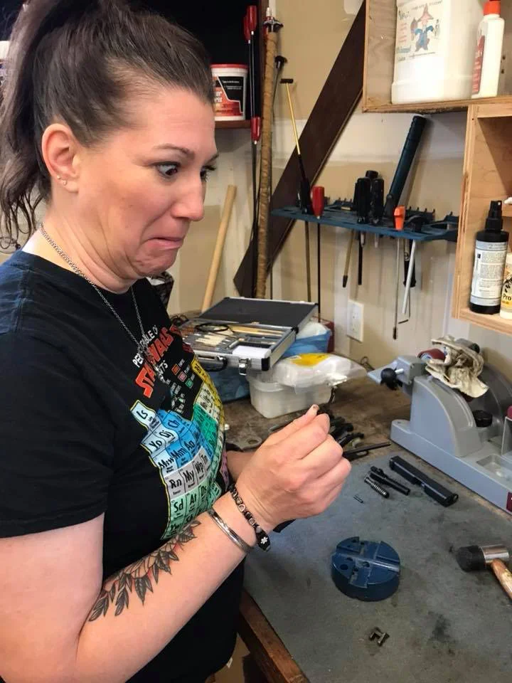 AJ looking worried cleaning gun.webp