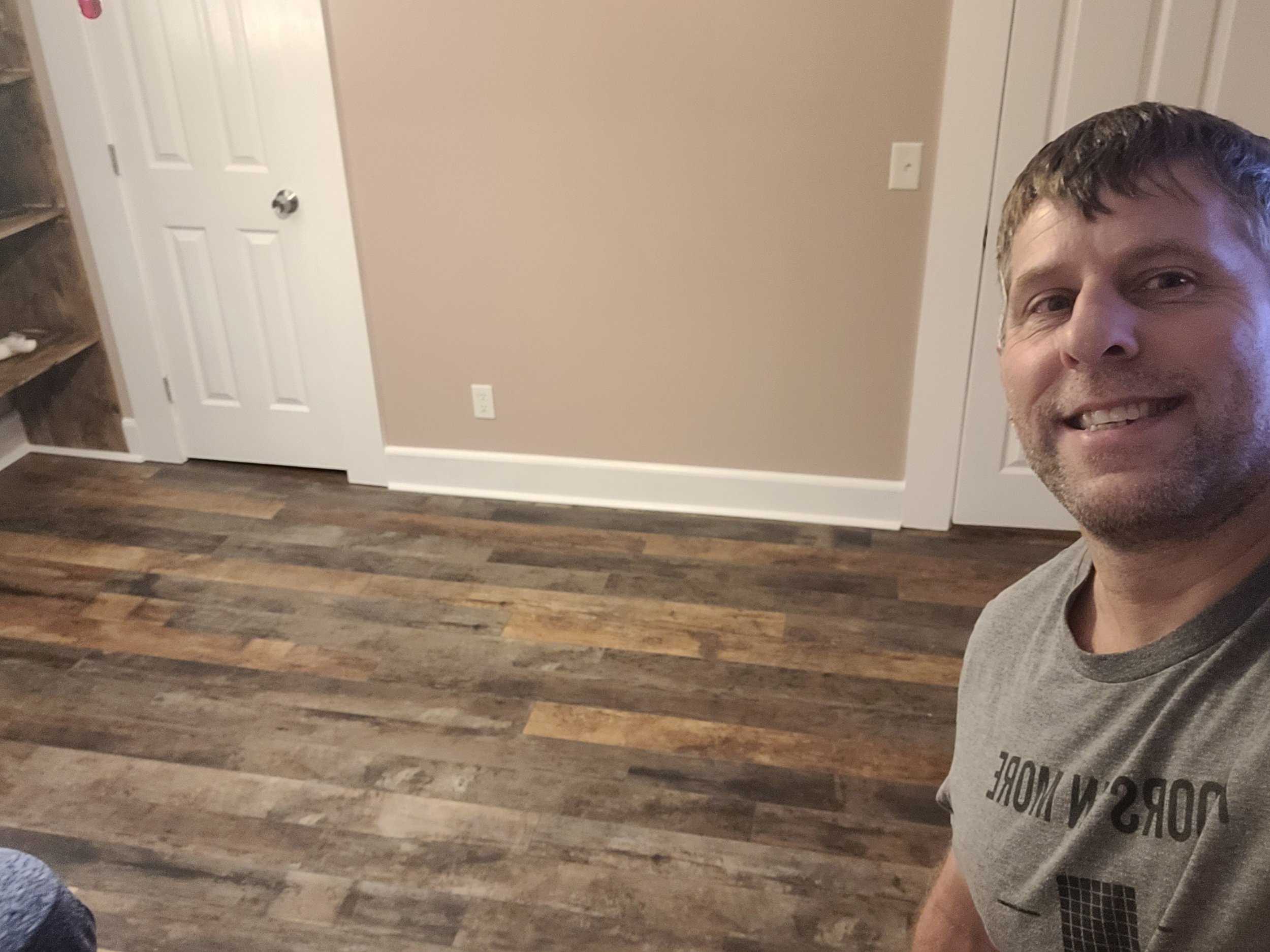 Completed waterproof laminate flooring in a finished residential room installed by a local flooring professional in Browns Summit, NC