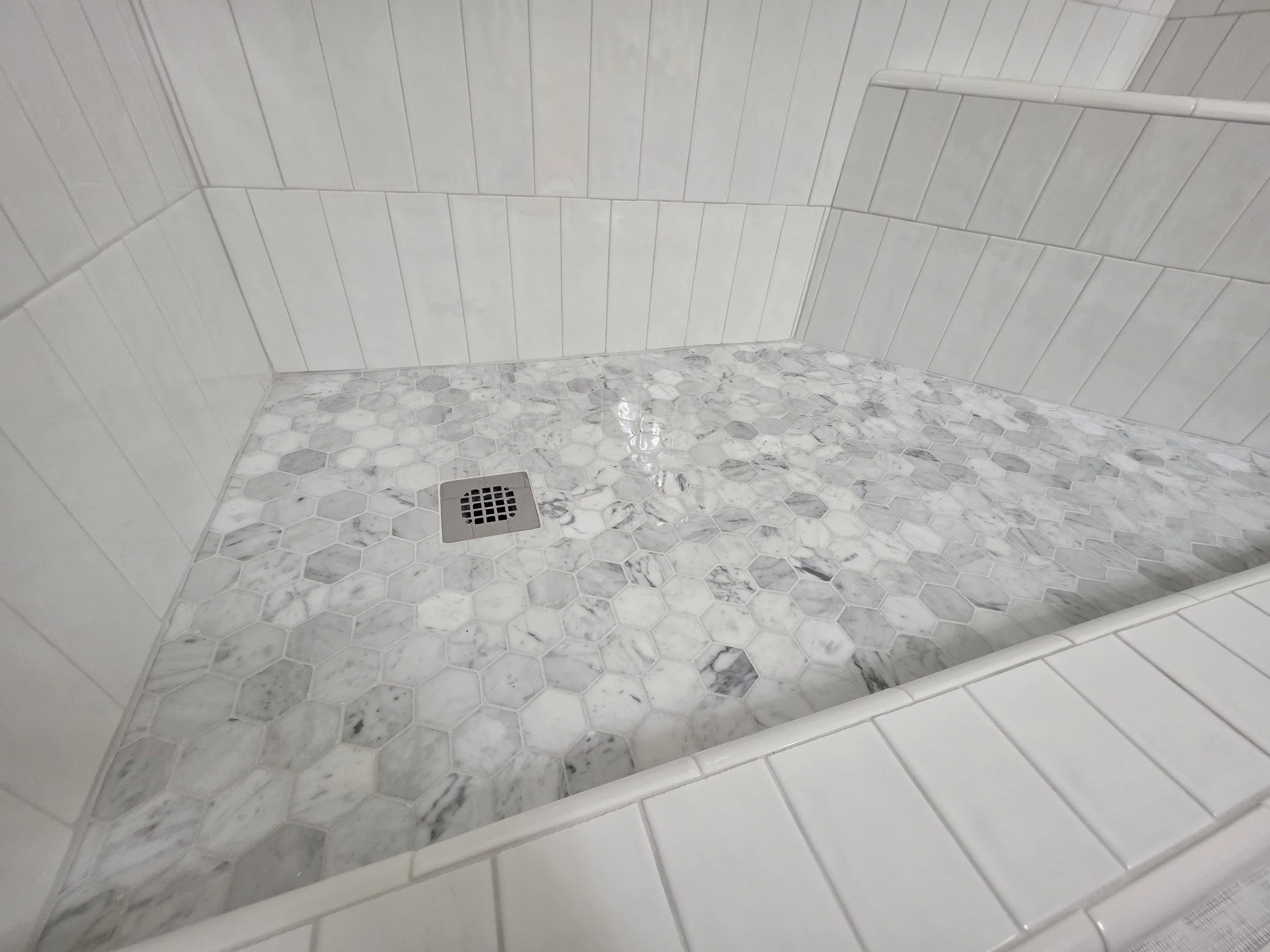 Mosaic tile shower floor with tiled curb and square drain in Greensboro, NC