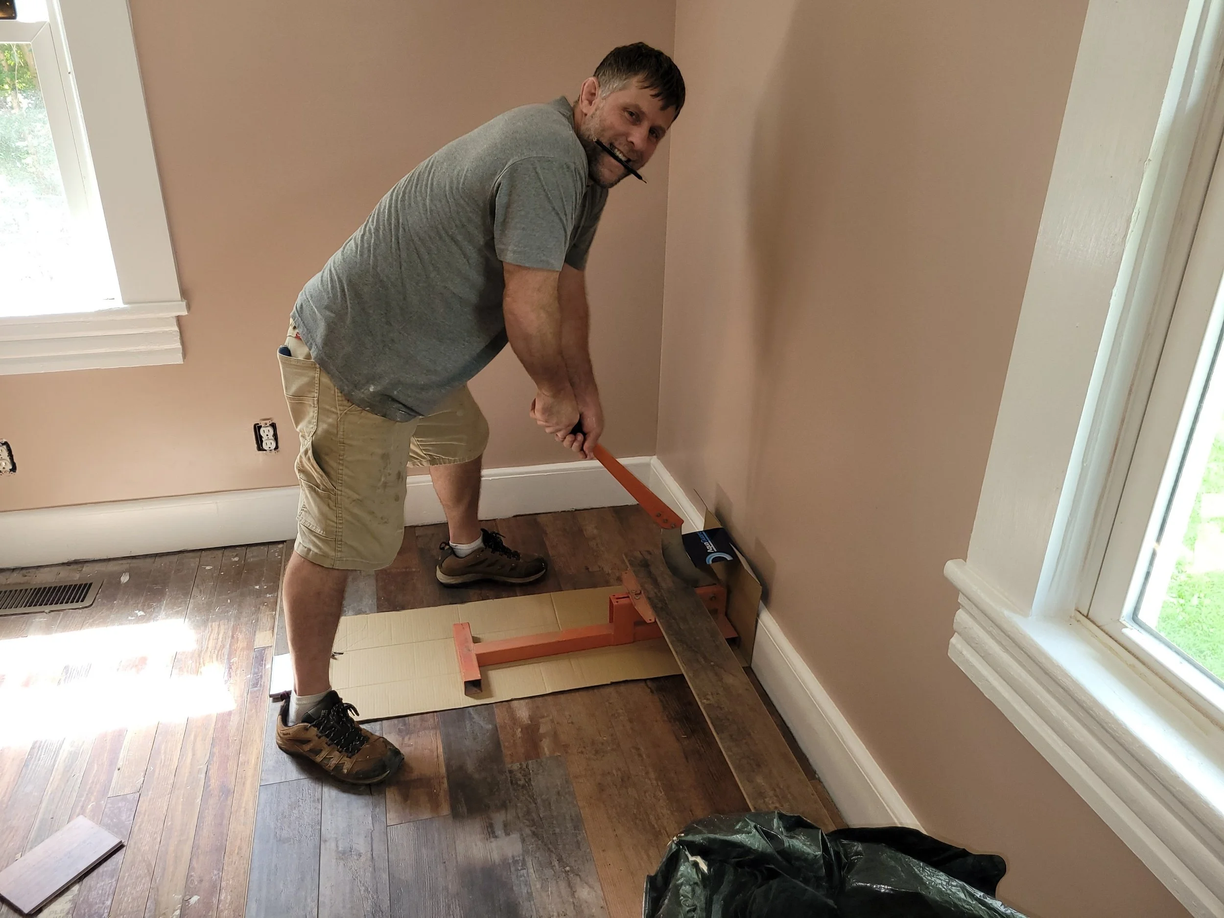 Waterproof laminate flooring being installed during a residential remodel by a local flooring contractor in the Greensboro Triad area