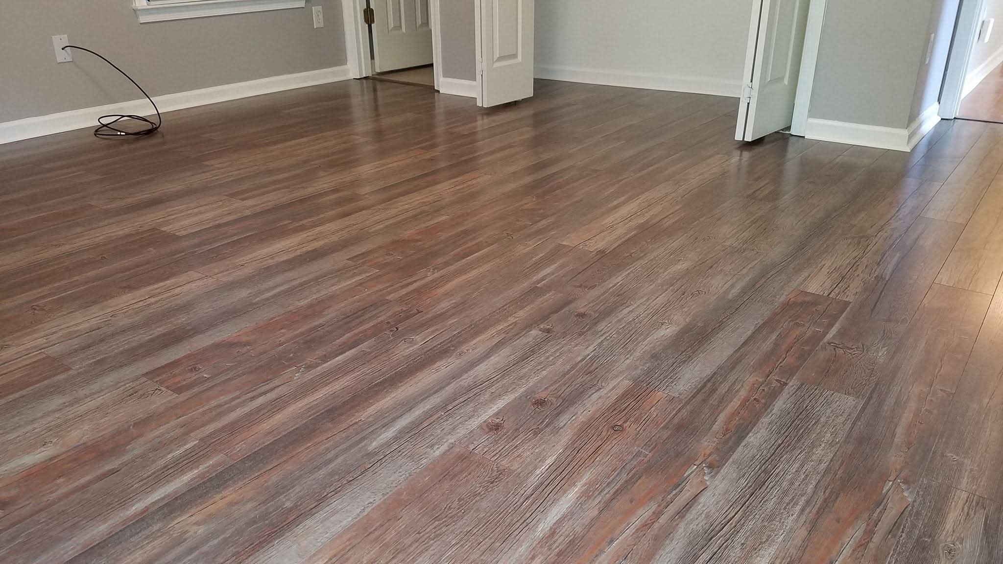 Finished laminate flooring installation in a residential room by a local flooring contractor in Browns Summit, NC