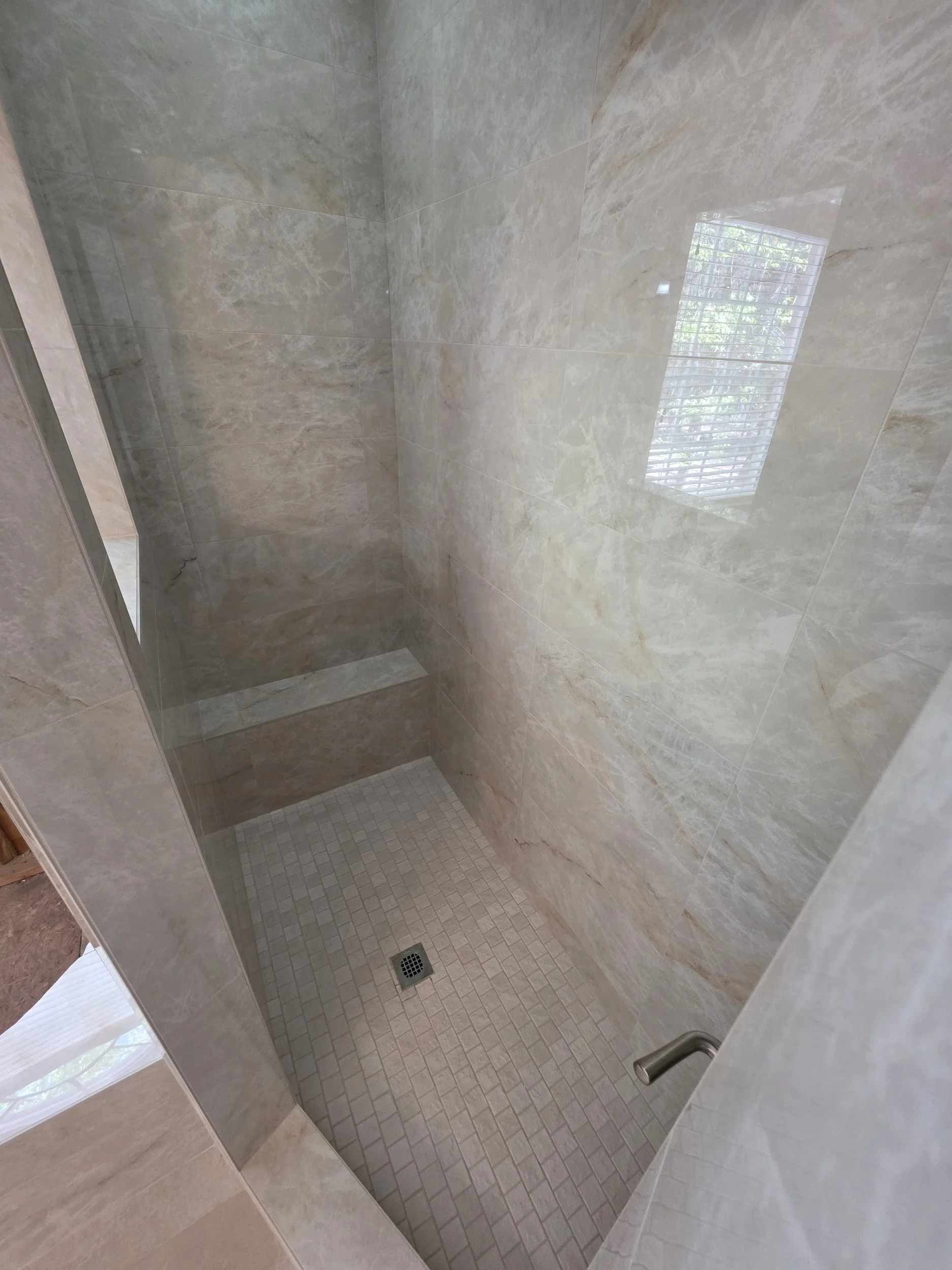 Finished custom tile shower with tiled shower floor and drain by Floors 'N More in Greensboro, NC