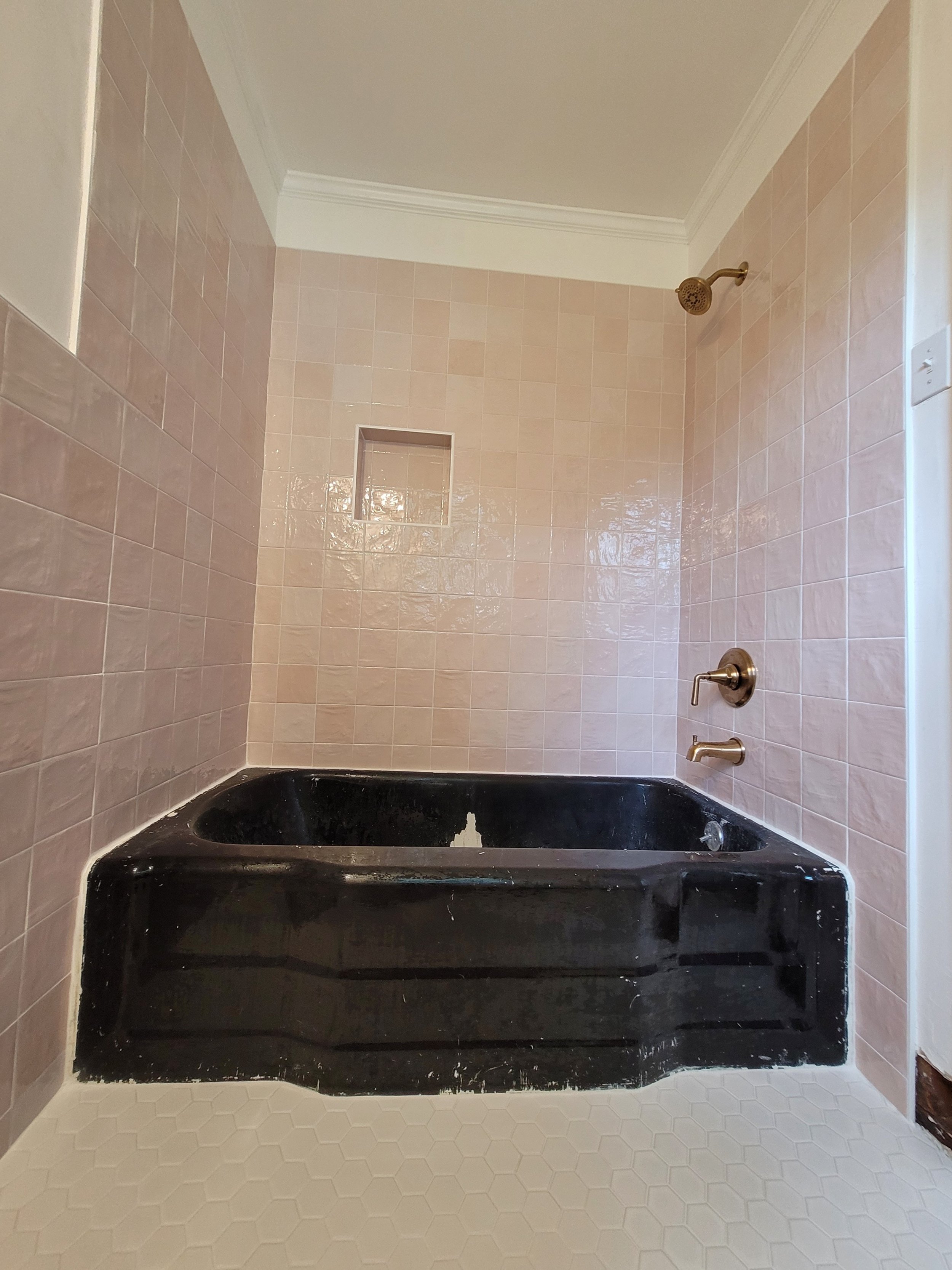 Custom tile shower and bathroom remodel with tiled walls and built-in niche completed by a local tile contractor in Brows Summit, NC