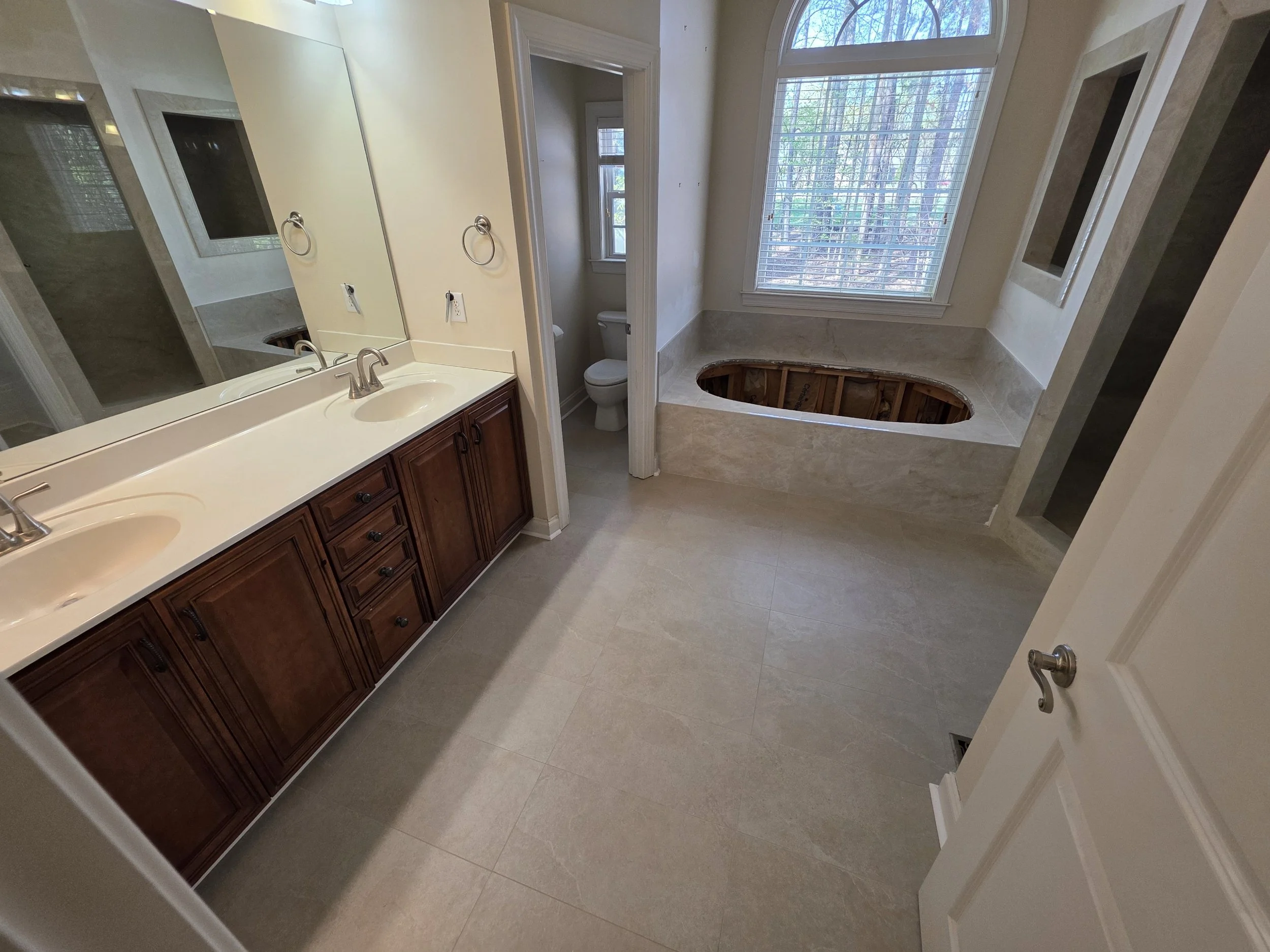 Bathroom remodel with double vanity and tile flooring in Greensboro NC