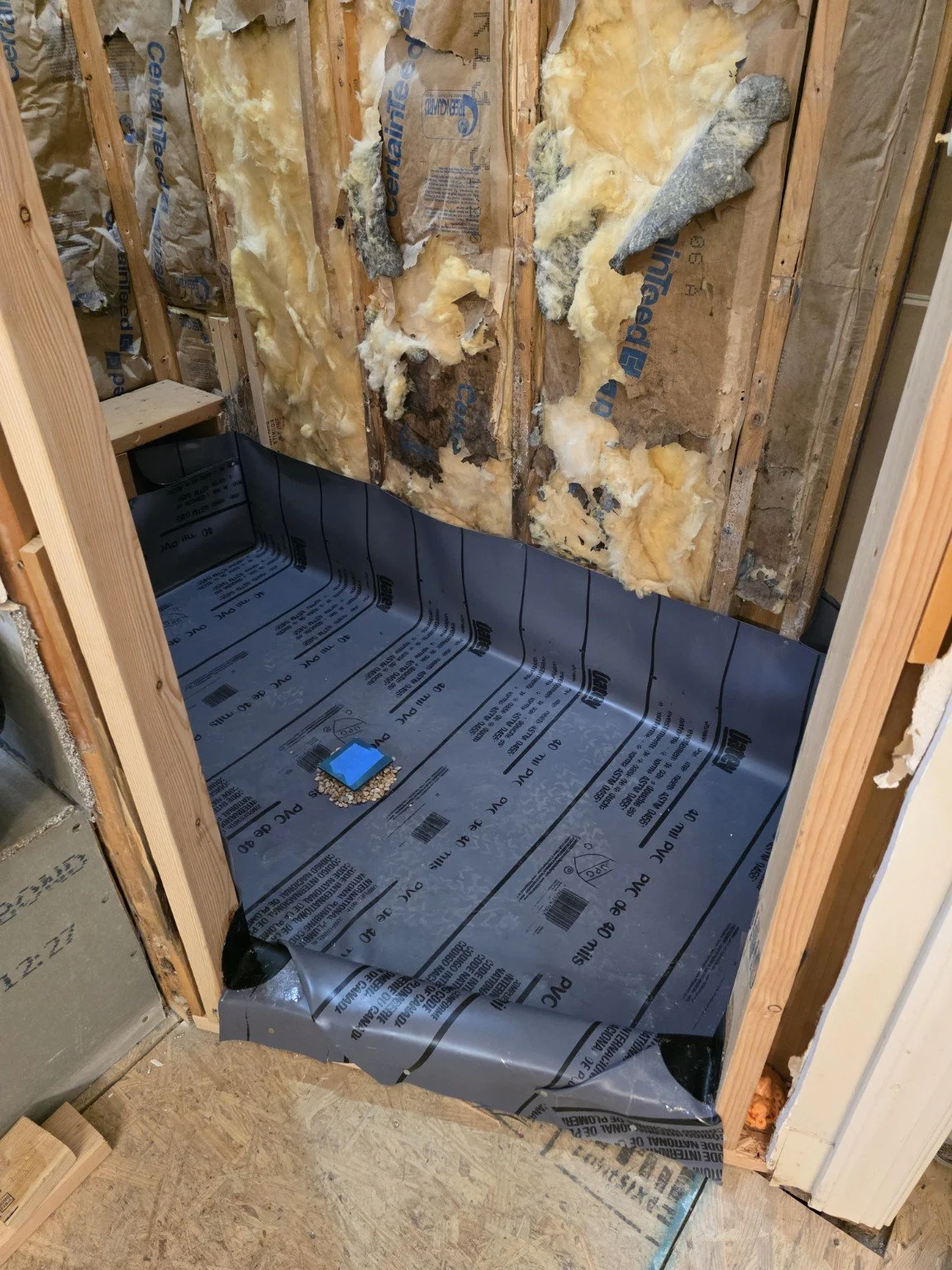 PVC shower pan liner and drain installed over a pre-slope after subfloor repairs in Browns Summit, NC.