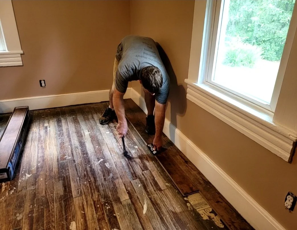 Waterproof laminate flooring installation in progress during a residential remodel in the Greensboro Triad area
