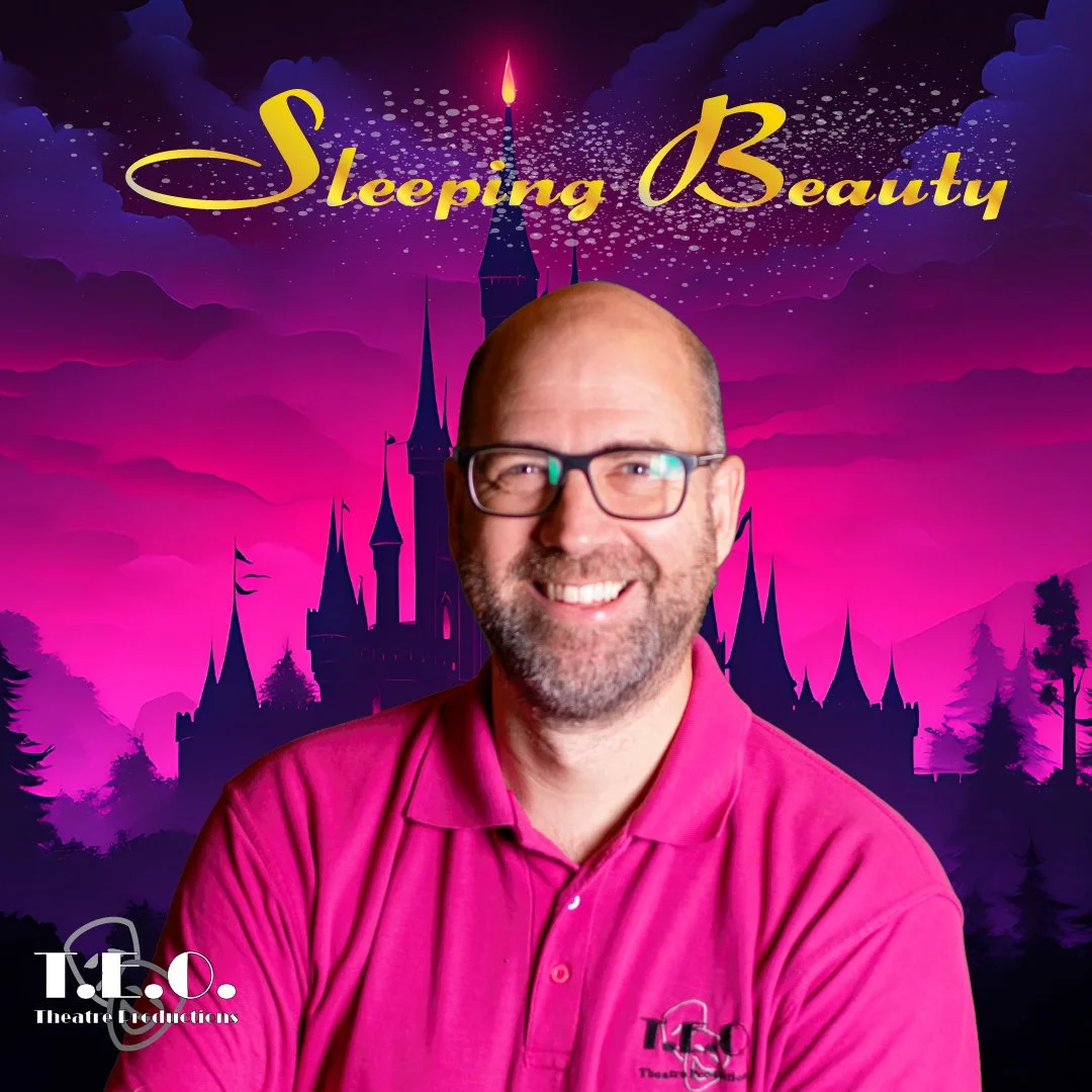 A man with glasses and a beard smiling, wearing a pink polo shirt, in front of a colorful background featuring a castle silhouette, pink sky, and the words 'Sleeping Beauty' in yellow script.