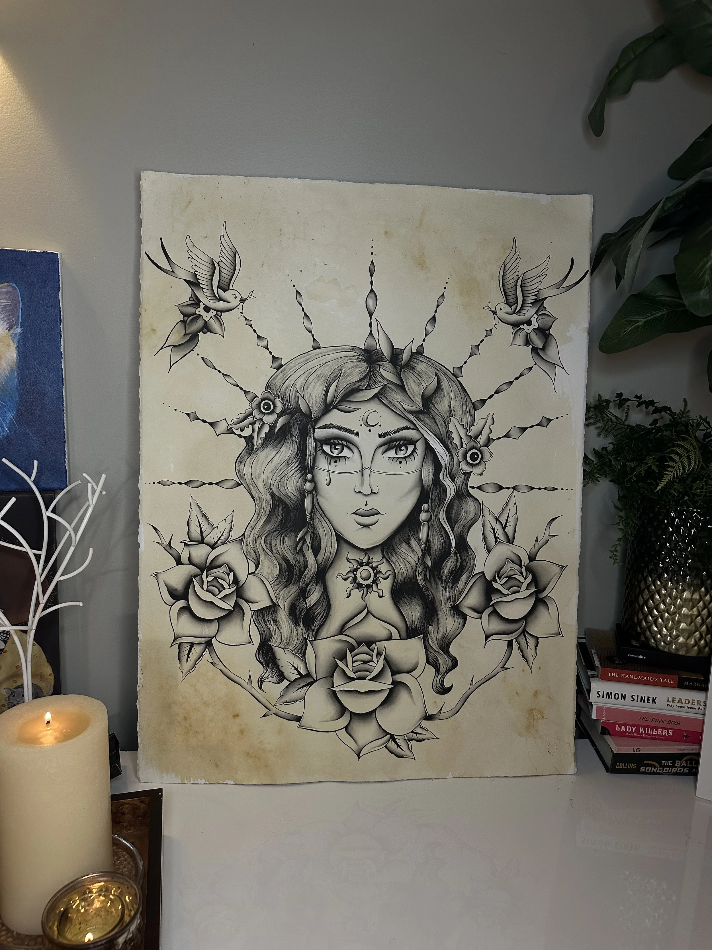Black and white illustration of a woman with long wavy hair, surrounded by roses, with birds and decorative elements in the background.