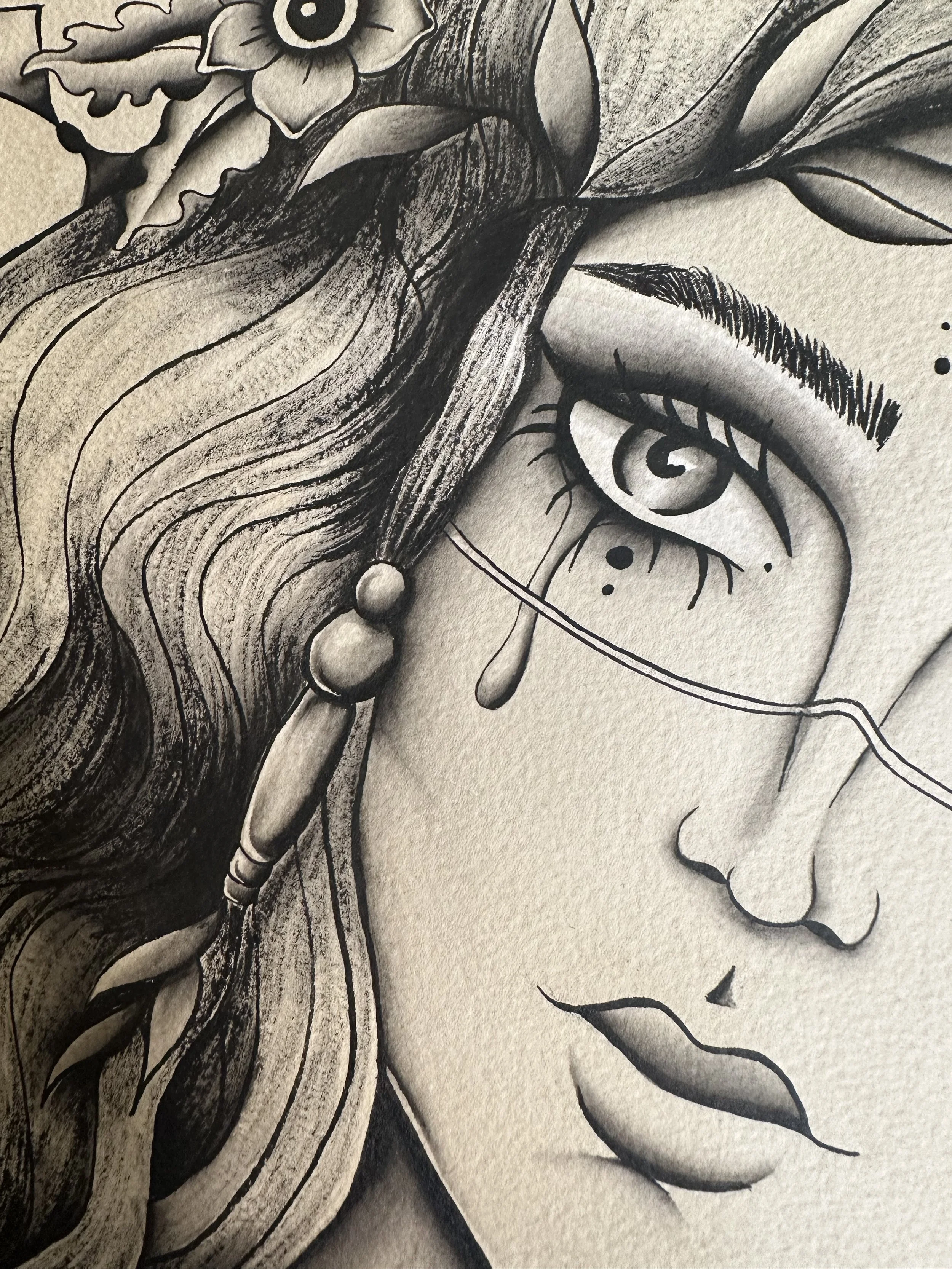A detailed black and white drawing of a person's face with long wavy hair and tears, featuring large expressive eyes, bold eyebrows, and part of the nose and lips visible.