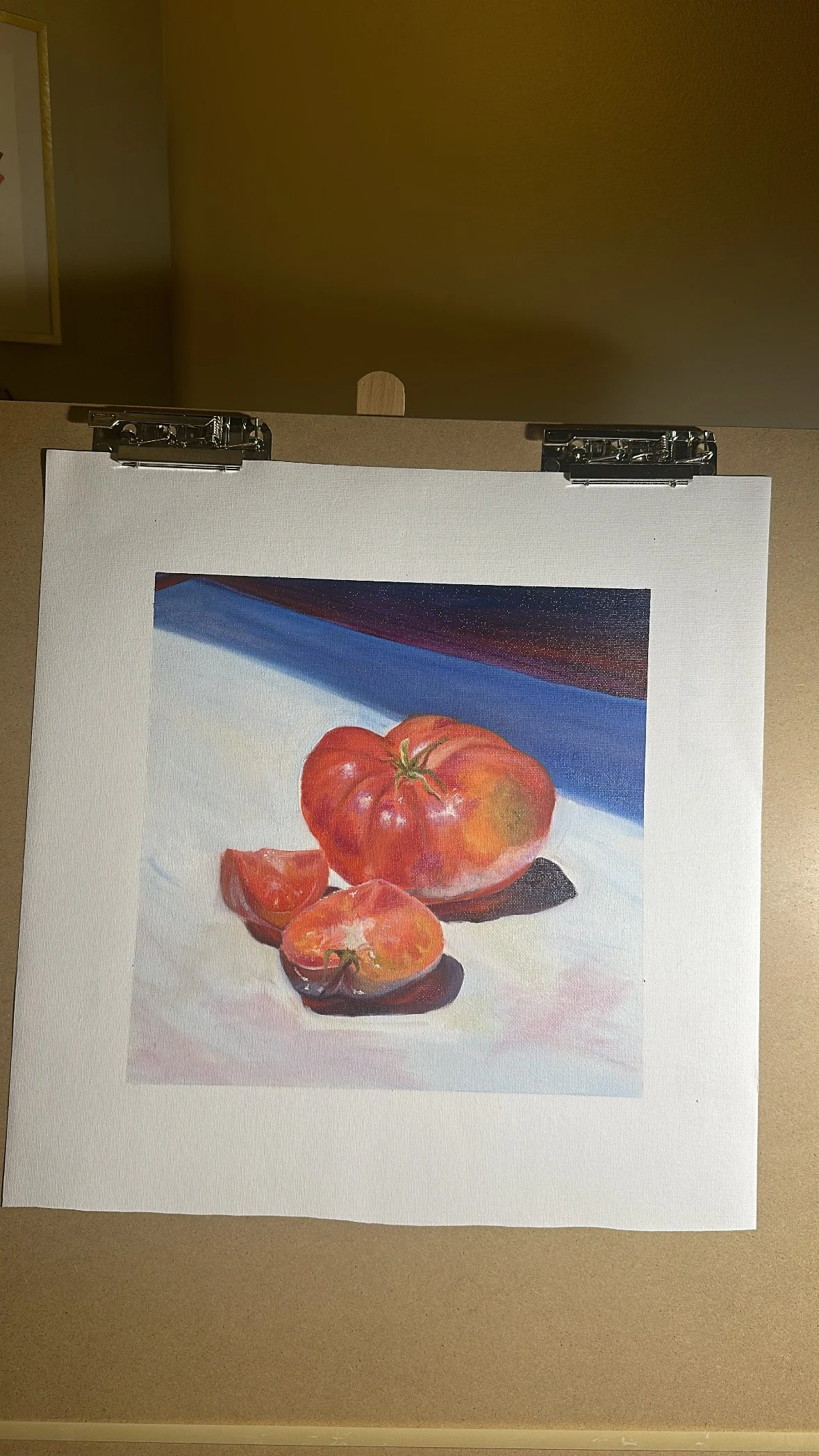 Painting of a tomato and tomato slices with a shadow on a light surface.