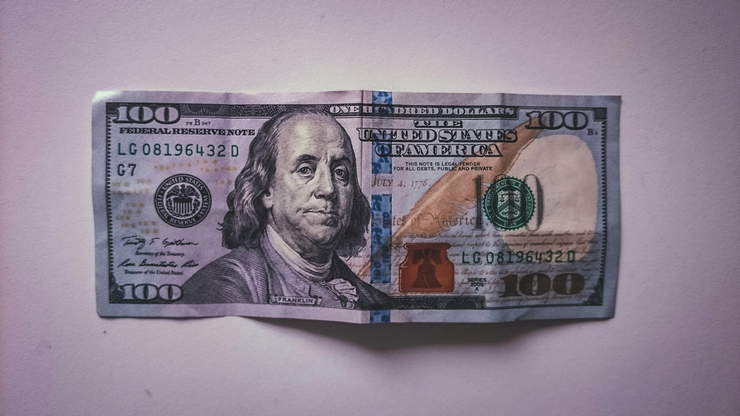 A one hundred dollar bill set against a neutral background. Representing the insights of Fairfield Financial Advisors on flexible financial planning.