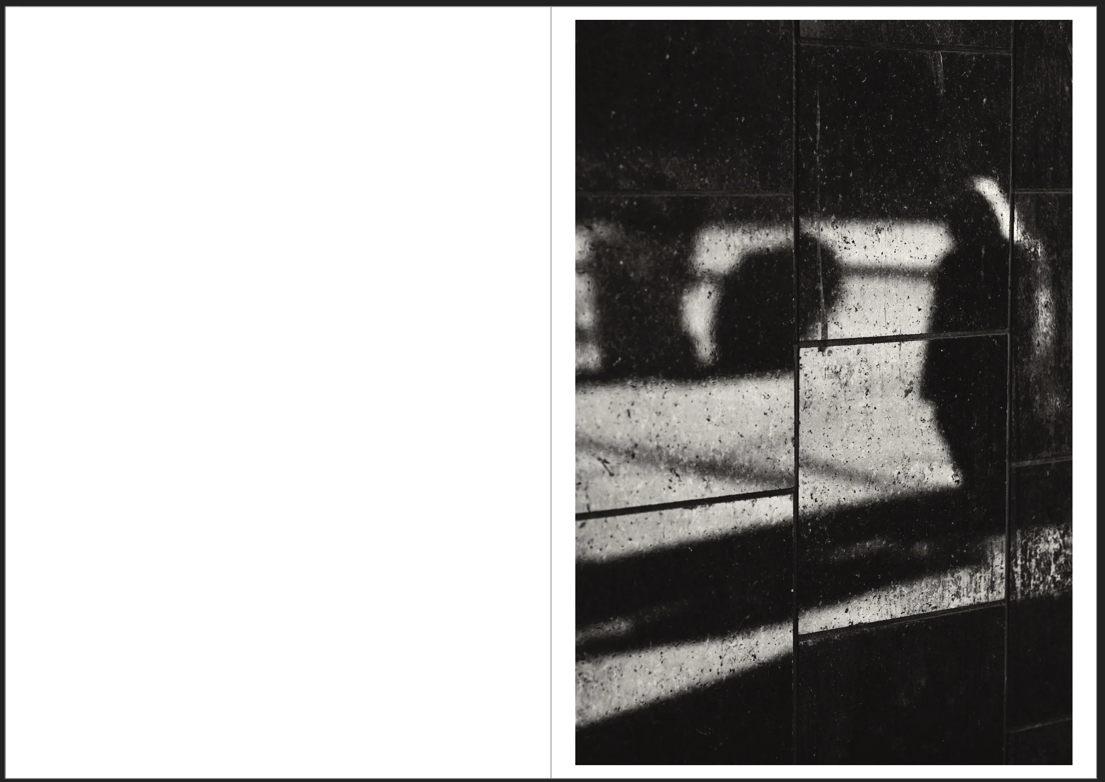 Reflection of a person taking a photograph on a rain-speckled tiled surface.