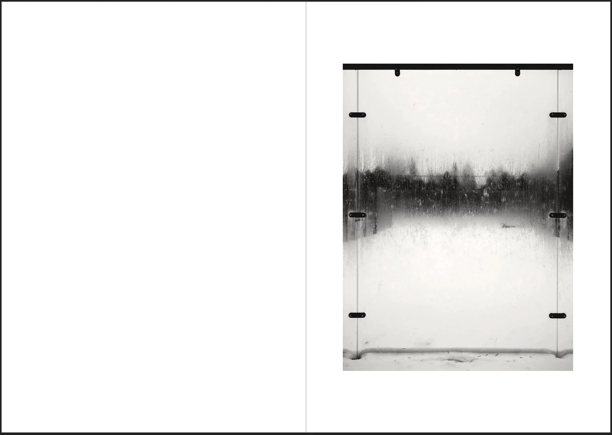 A rectangular metallic surface with black hinges or brackets, with a gradient of black and gray streaks, and a white background.