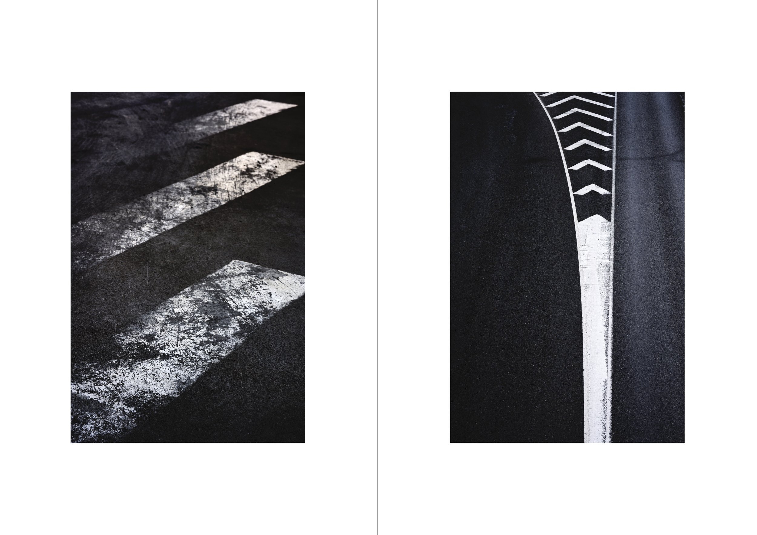 Sidewalk with worn crosswalk paint on dark asphalt on the left, and a new painted crosswalk with white lines on dark asphalt on the right.