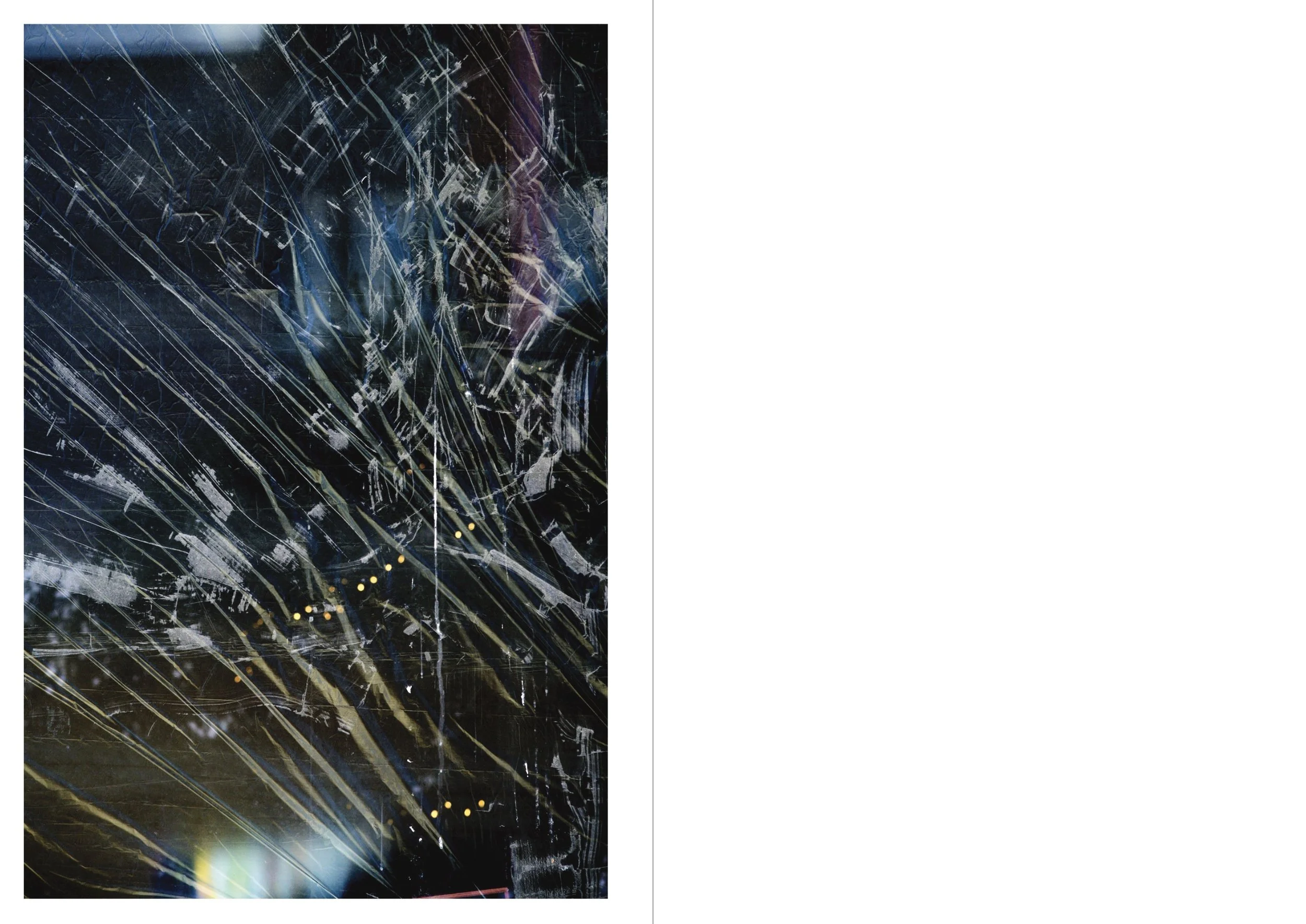 Close-up of shattered glass with streaks and reflections, creating an abstract pattern.