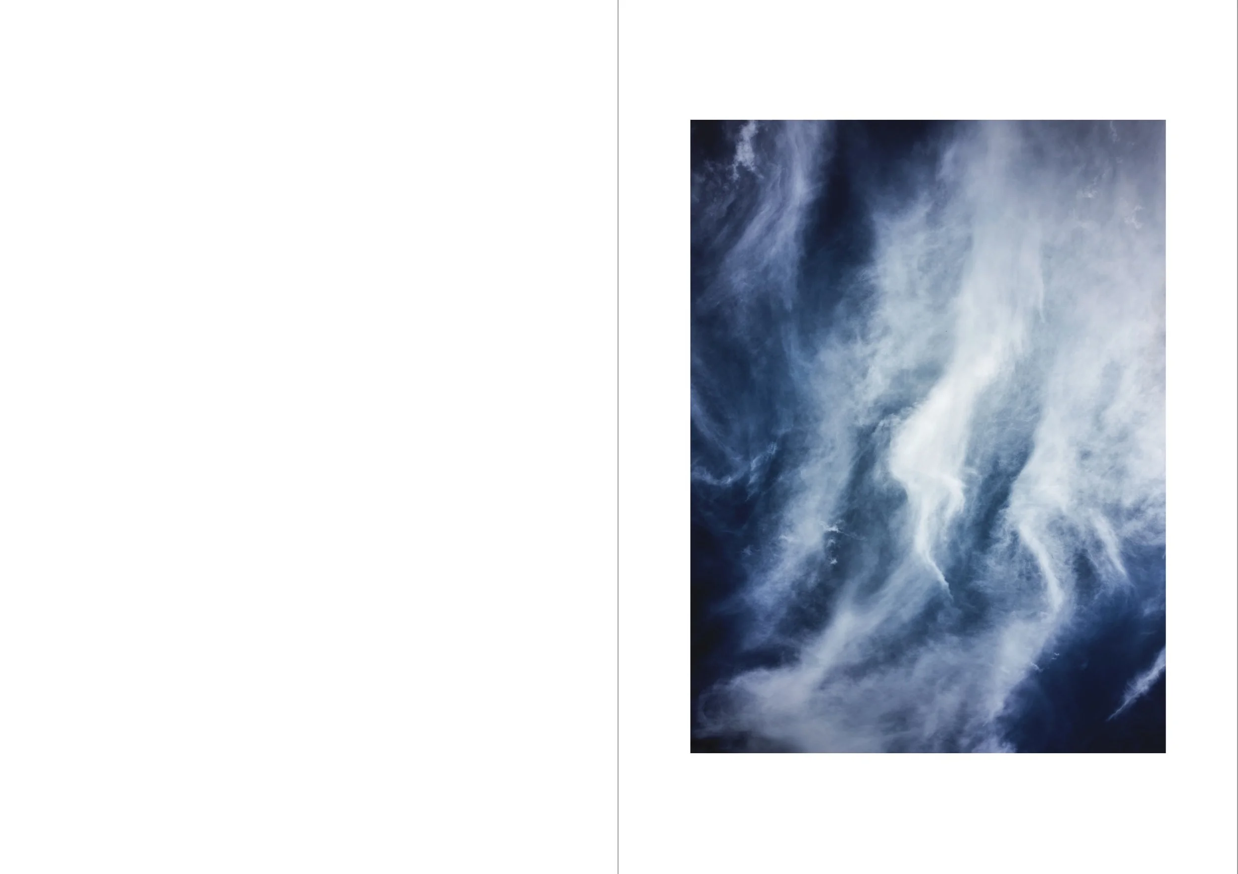 Cloudy sky with dark and light clouds stretching across.