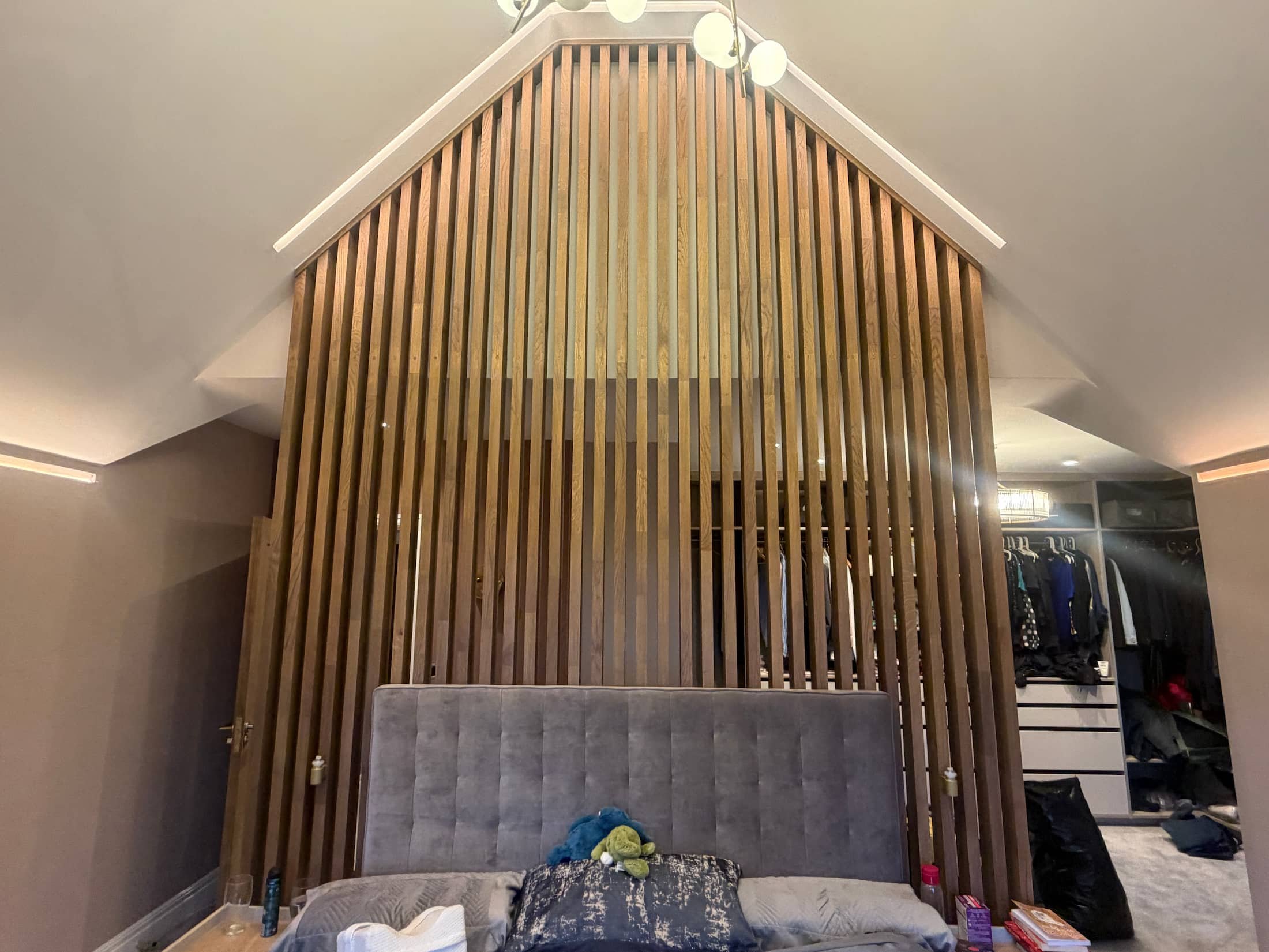 Decorative timber slat feature wall in a residential bedroom in Harpenden, Hertfordshire