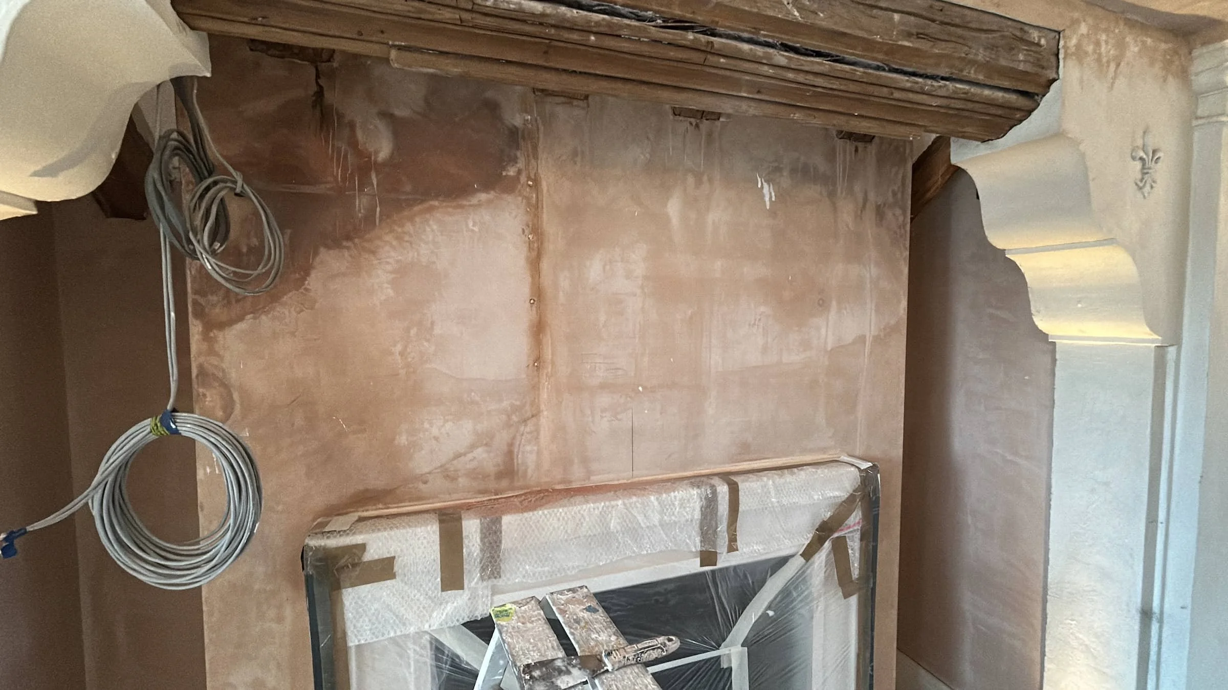 Period fireplace with decorative columns and timber beam before heritage restoration in Harpenden, Hertfordshire