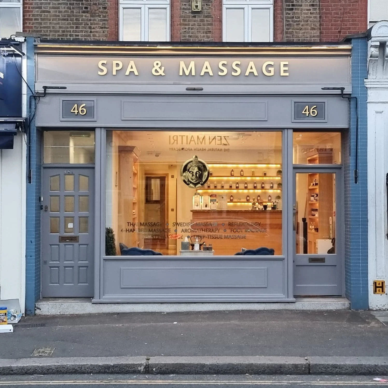 Spray-painted commercial shopfront for a spa and massage premises in North London