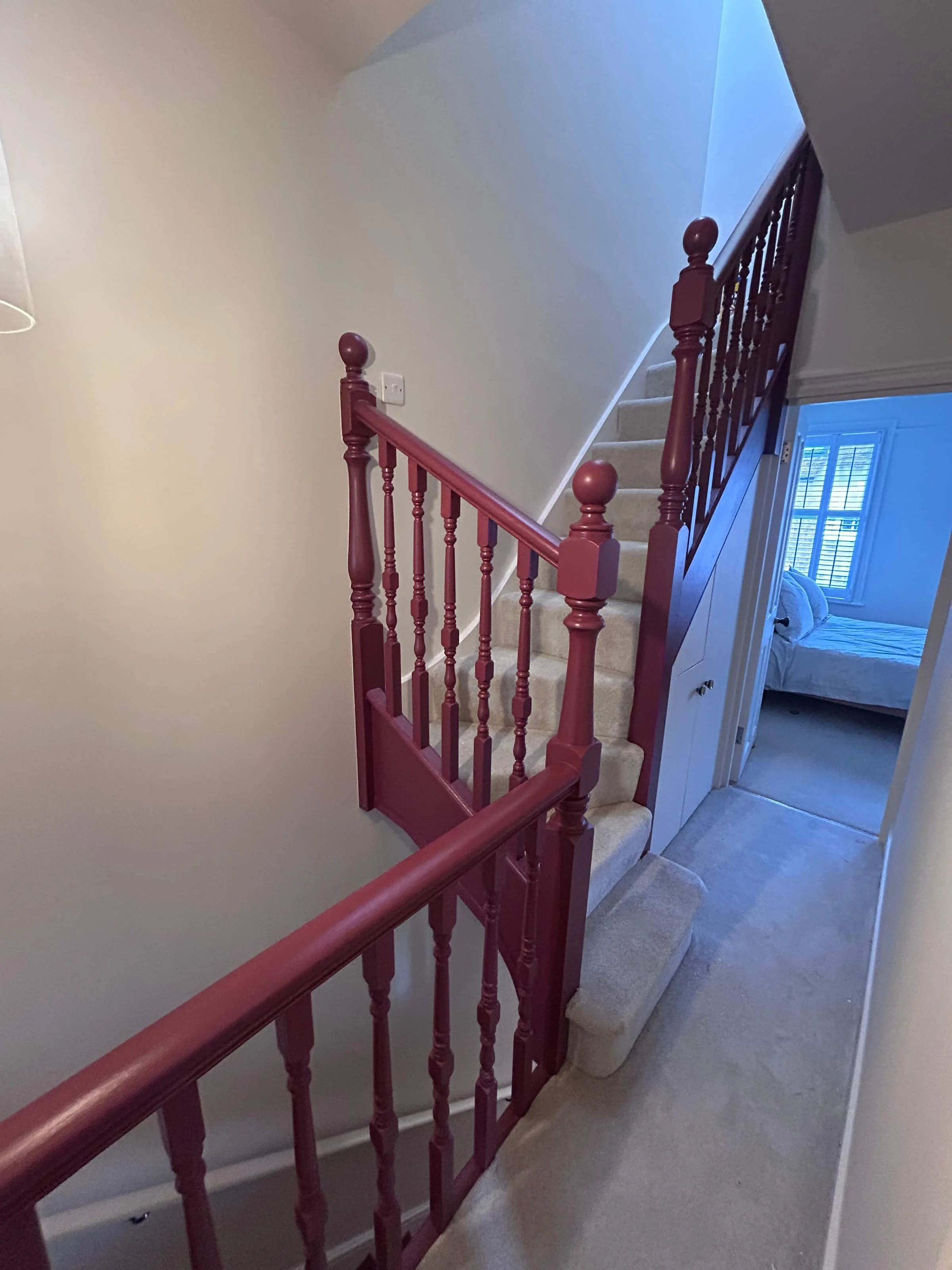 Painted burgundy staircase, banister and hallway in St Albans, Hertfordshire