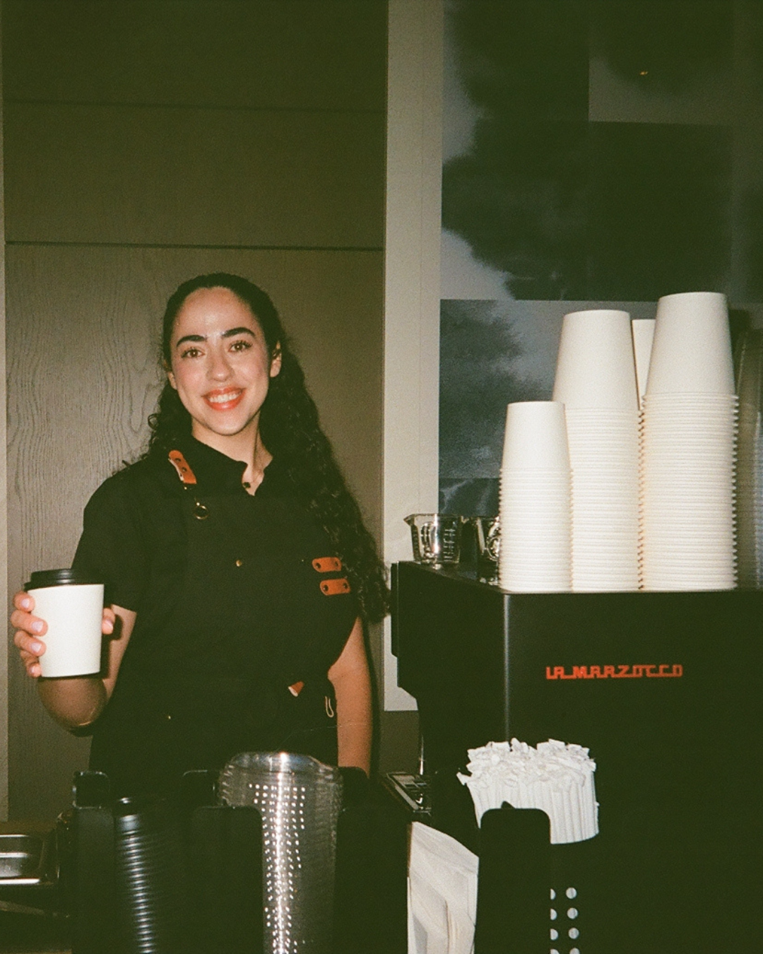 owner and head barista for charlotte mobile coffee with linea mini machine and coffee cups