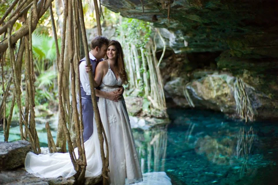 Bride and Groom surrounded by the natural beauty of Riviera Maya in a Cenote