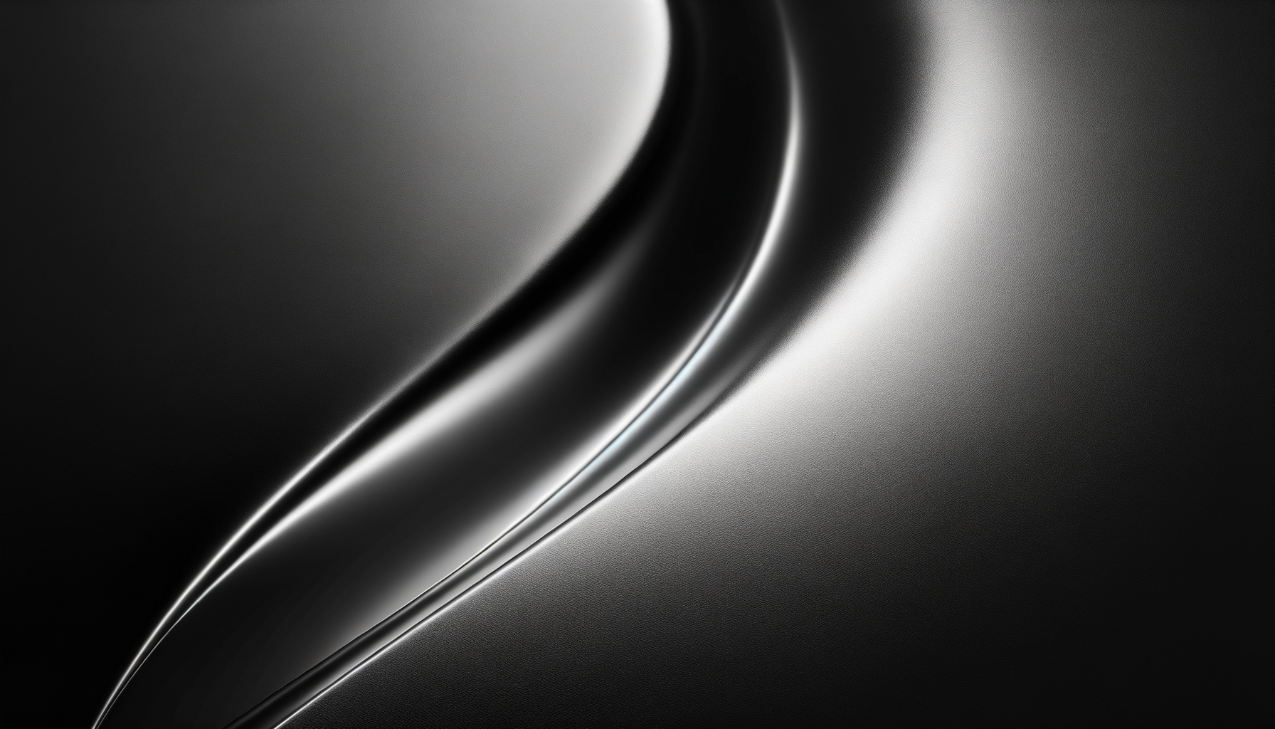 Close-up of a sleek, metallic object with smooth, curved surfaces and shiny edges, illuminated with soft lighting.