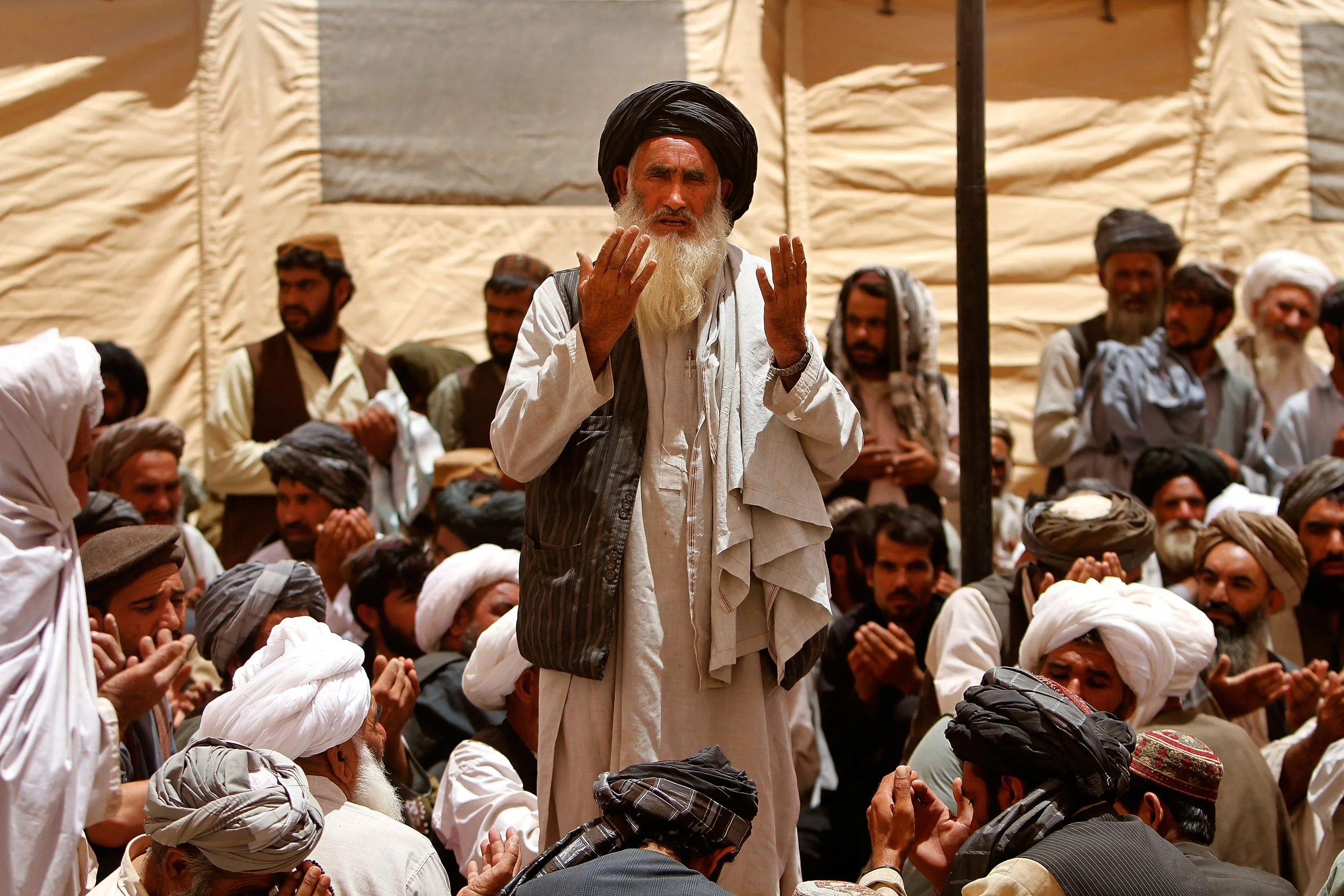 Elders pray during a meeting – or shura – held to discuss community concerns in Marjah, Afghanistan.