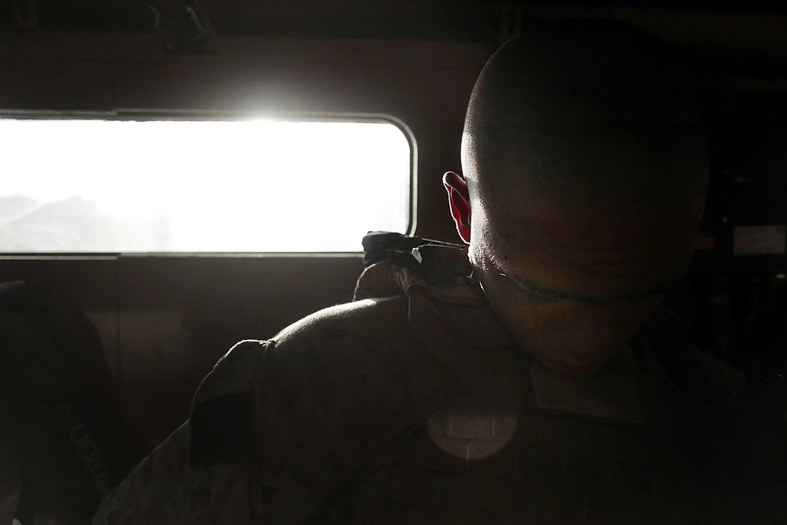 Work and heat take their toll. Lance Cpl. Anthony Antonich dozes off inside an MRAP while waiting for his convoy to roll out in the early morning hours in Marjah, Afghanistan.