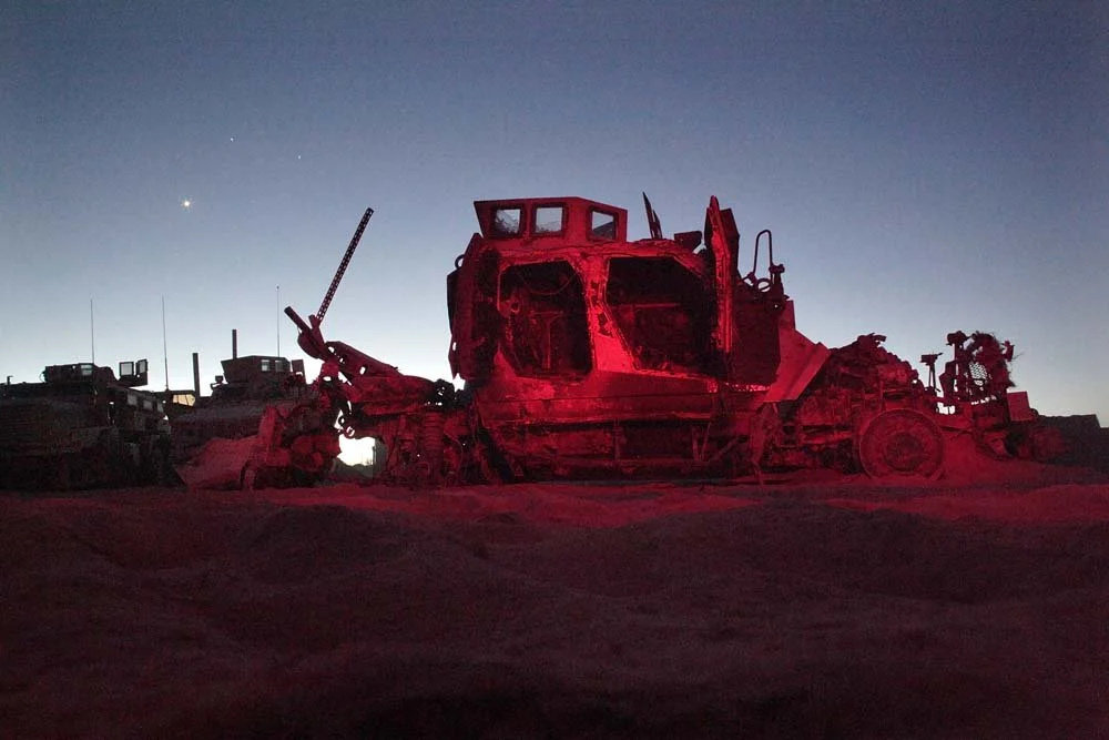 This MRAP-All Terrain Vehicle (MATV), scarred by an IED blast, was towed back to Camp Hansen. Remarkably, the Marines inside survived — a testament to the armored vehicle’s design and their sheer luck in a war zone where survival is never guaranteed.