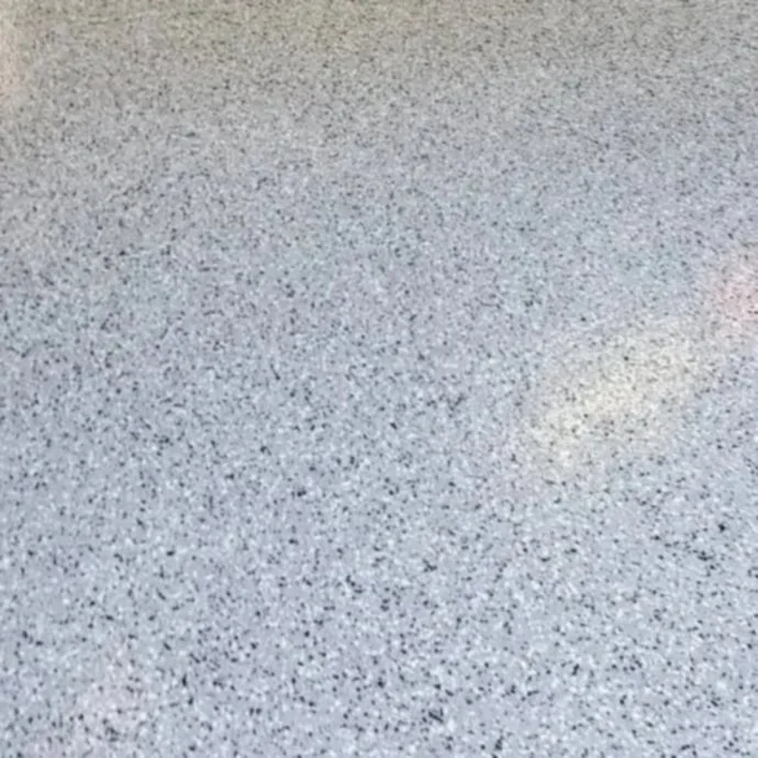 Close-up of a textured gray speckled surface, likely a terrazzo or similar flooring material.
