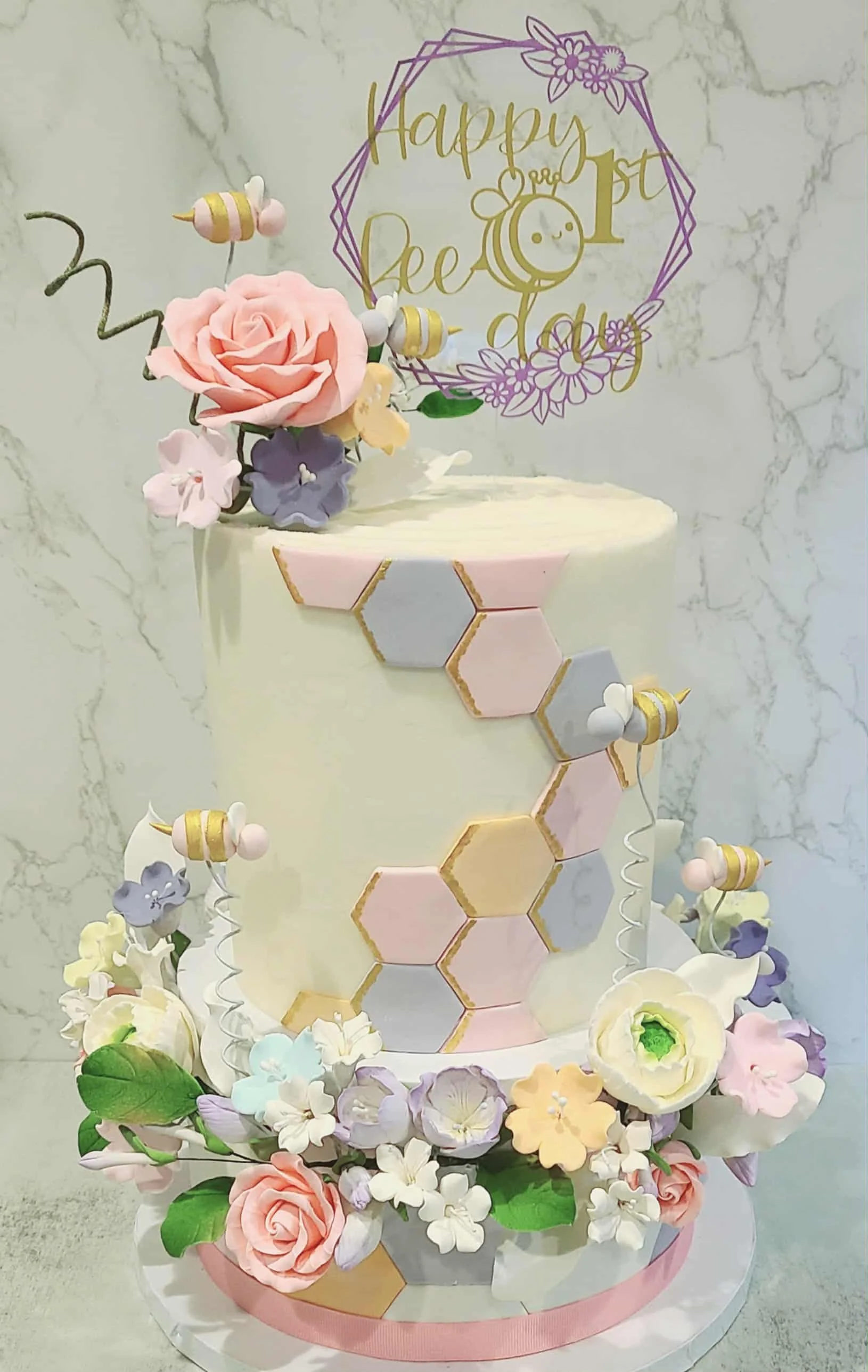 1st Birthday white cake with pastel honeycomb design