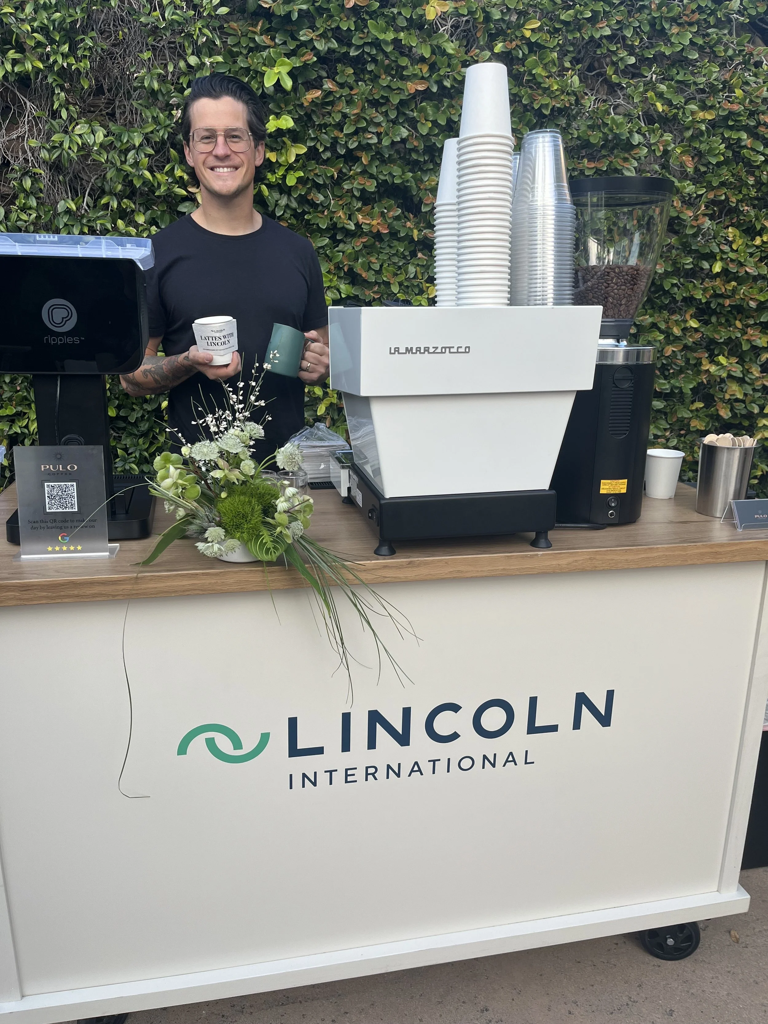Professional baristas providing mobile coffee cart catering with espresso service at a private corporate event in Los Angeles