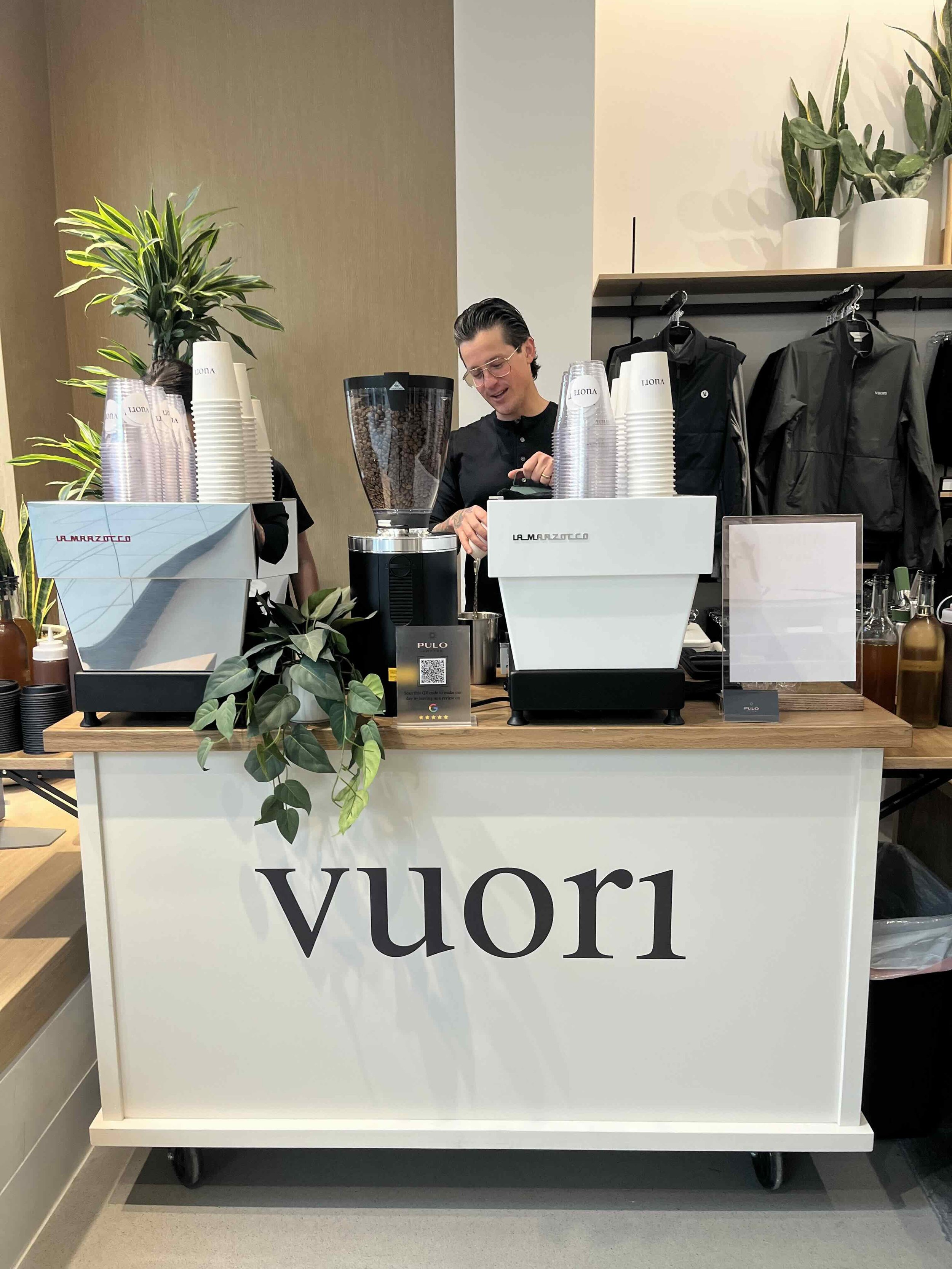 Pulo Coffee barista at a custom branded Vuori store brand activation serving matcha and specialty drinks in Los Angeles