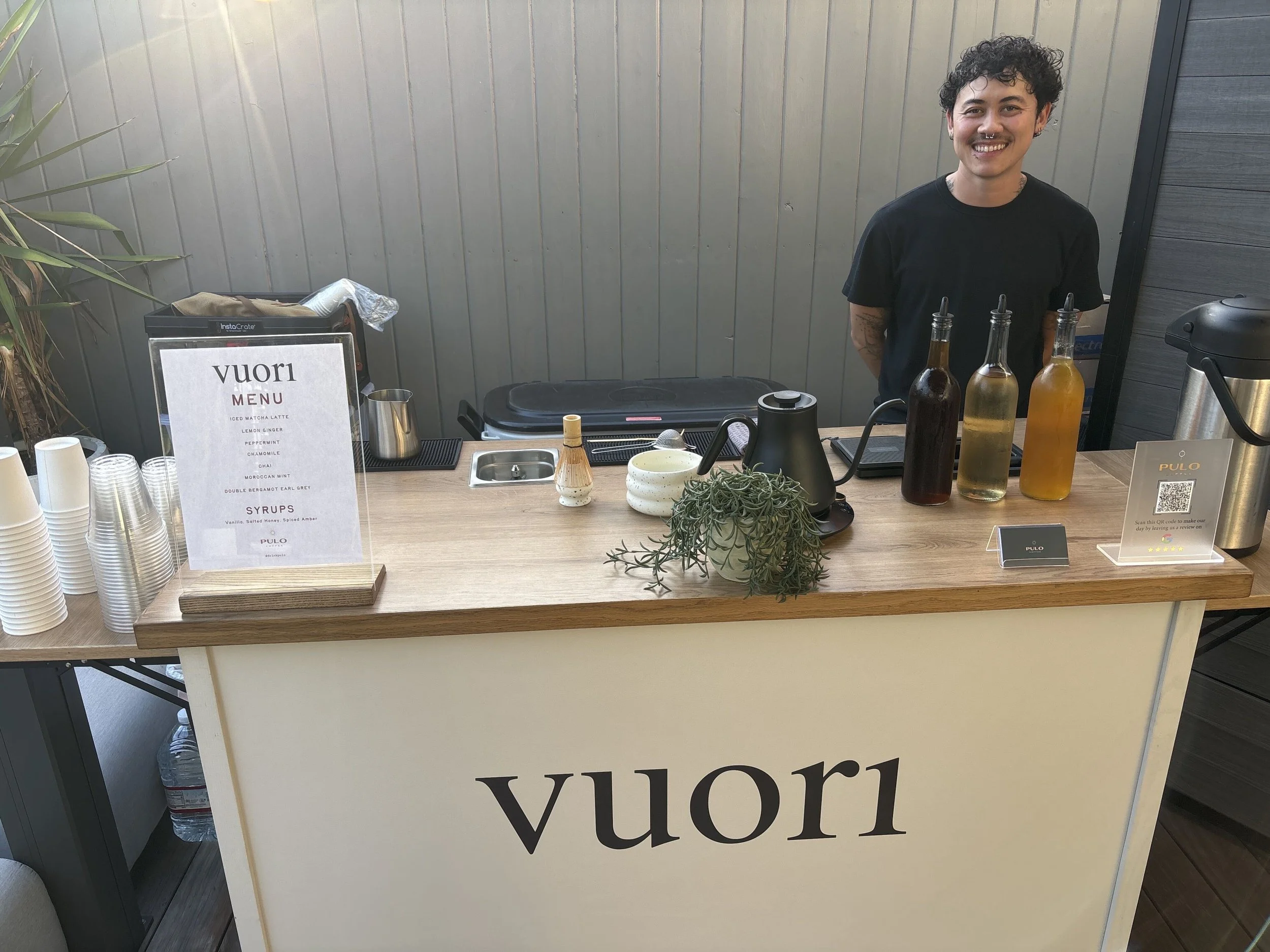 Pulo Coffee barista at Vuori branded matcha and tea bar with house-made syrups at Los Angeles brand activation