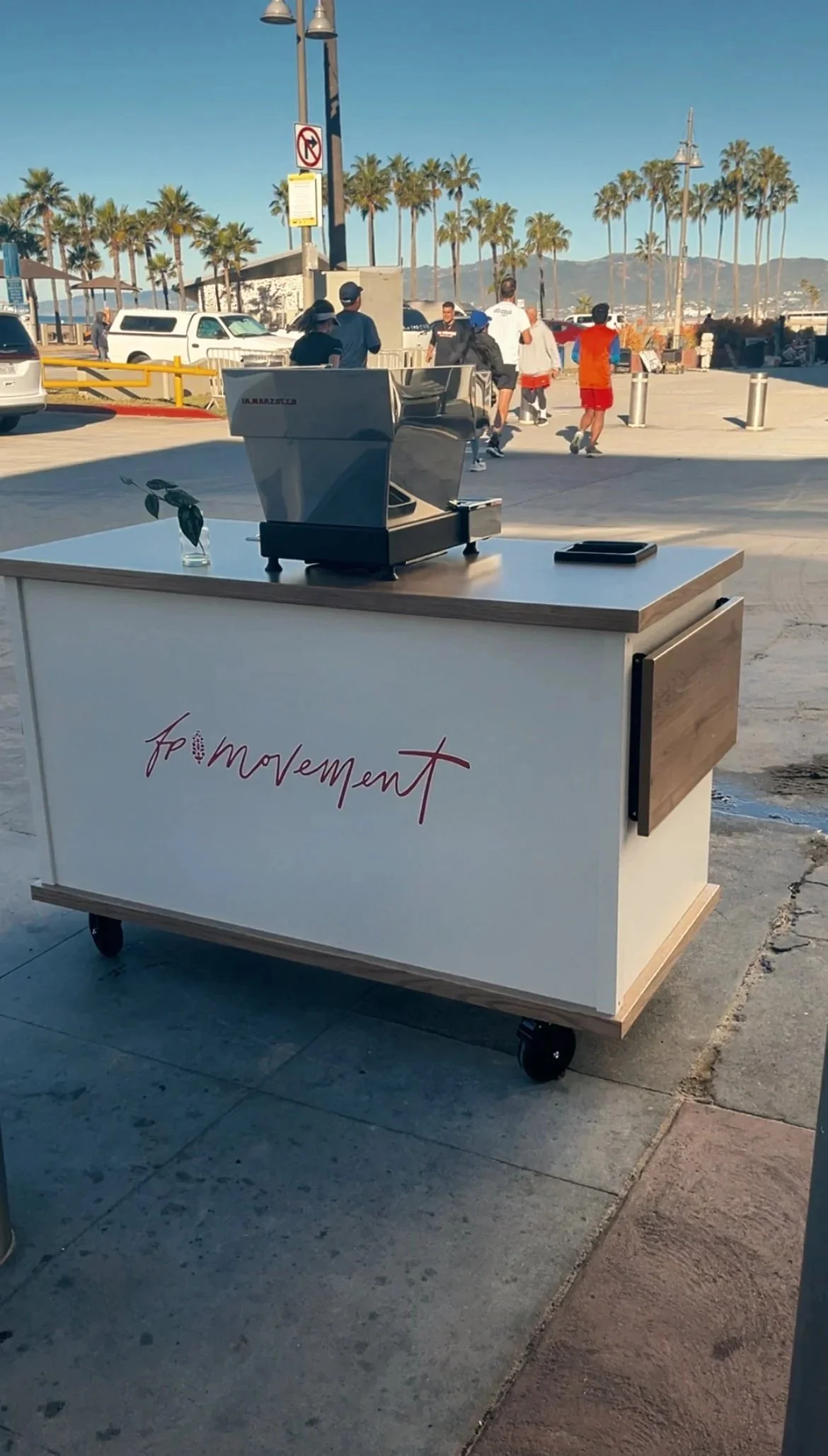 Experiential marketing coffee cart with custom branding and interactive logo latte art at community-based brand activation