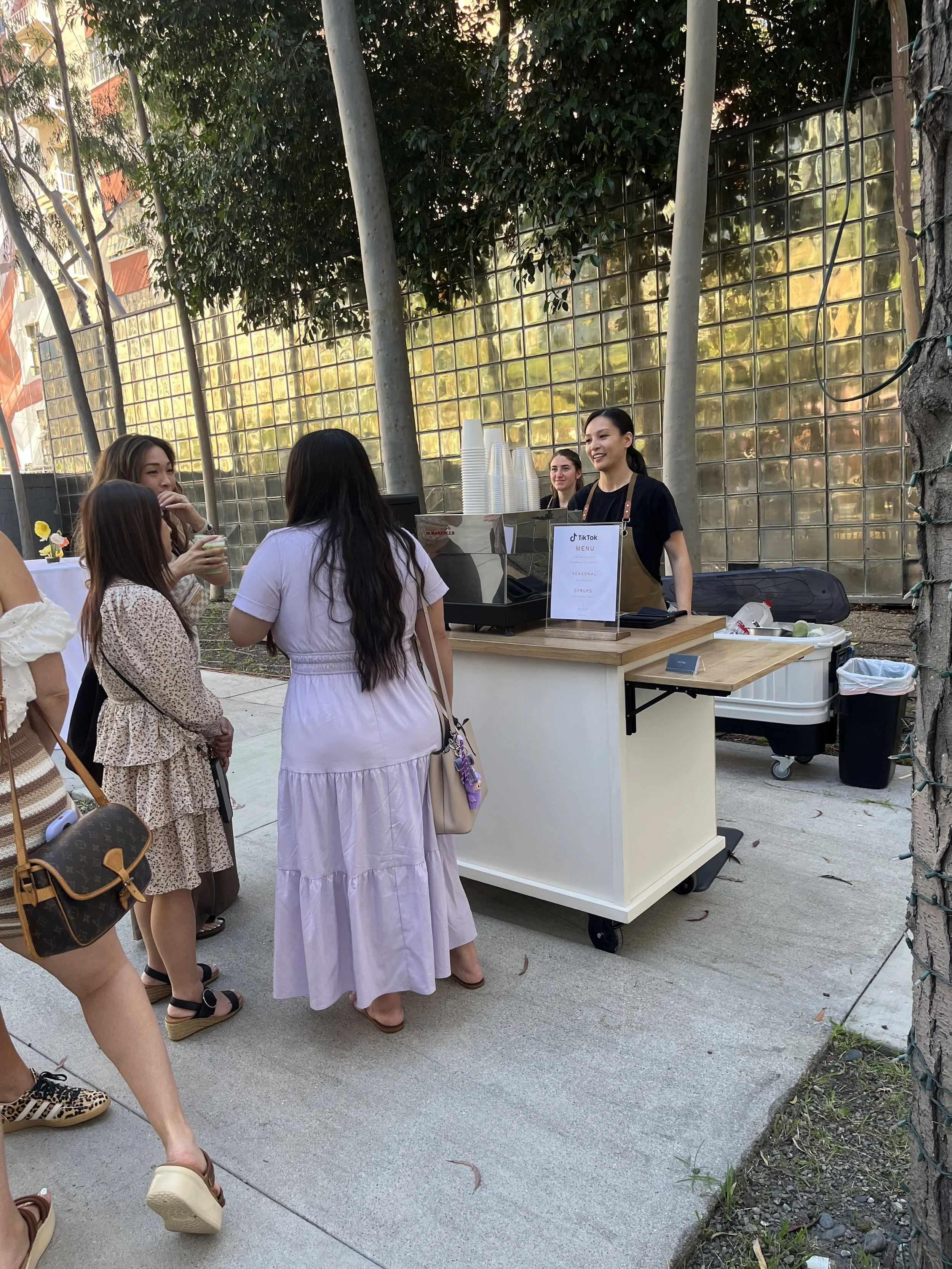 Guests lining up at a Pulo Coffee mobile matcha bar at an outdoor brand activation event in Los Angeles