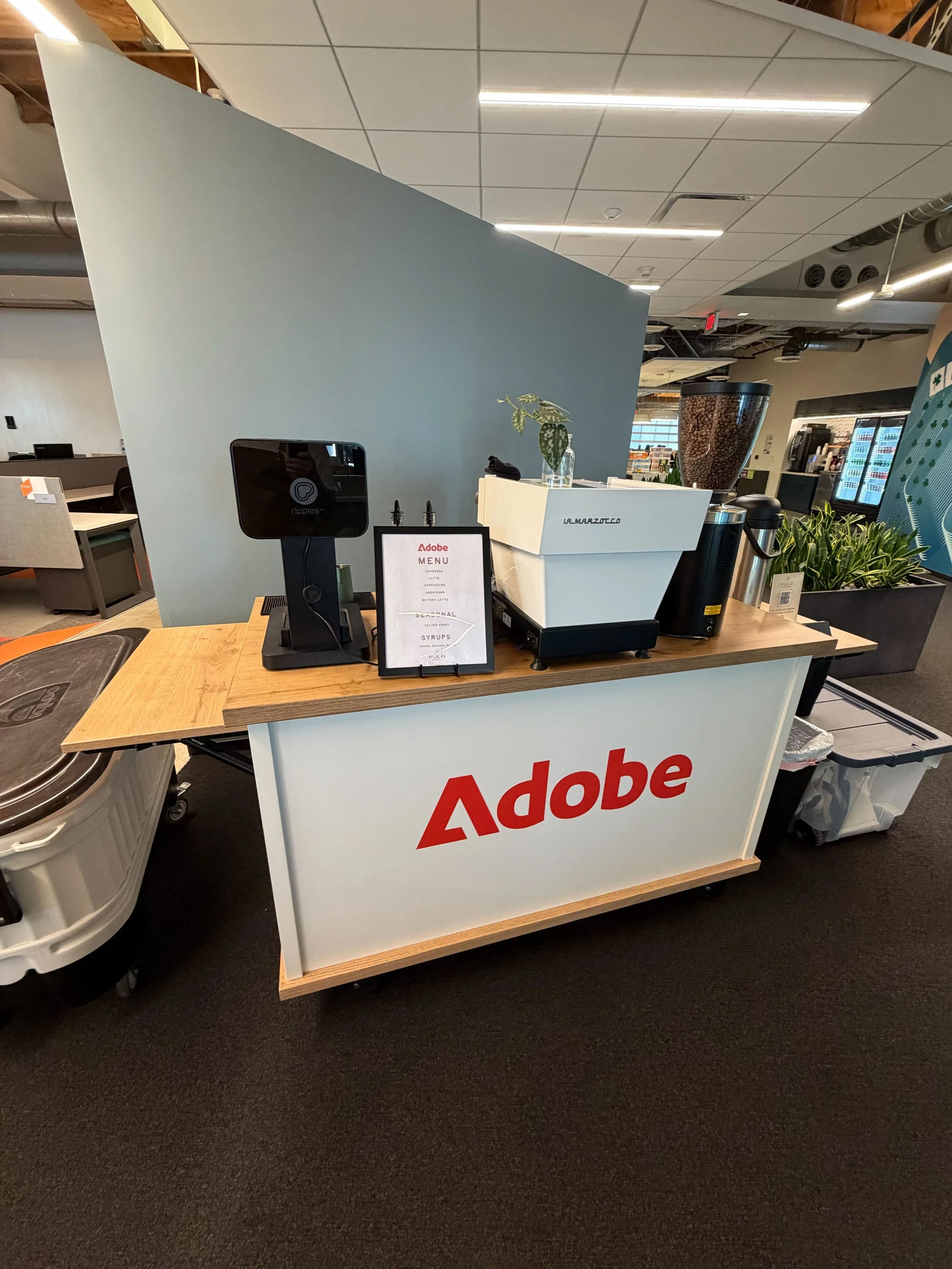 Custom branded coffee cart serving espresso drinks at an Adobe corporate event
