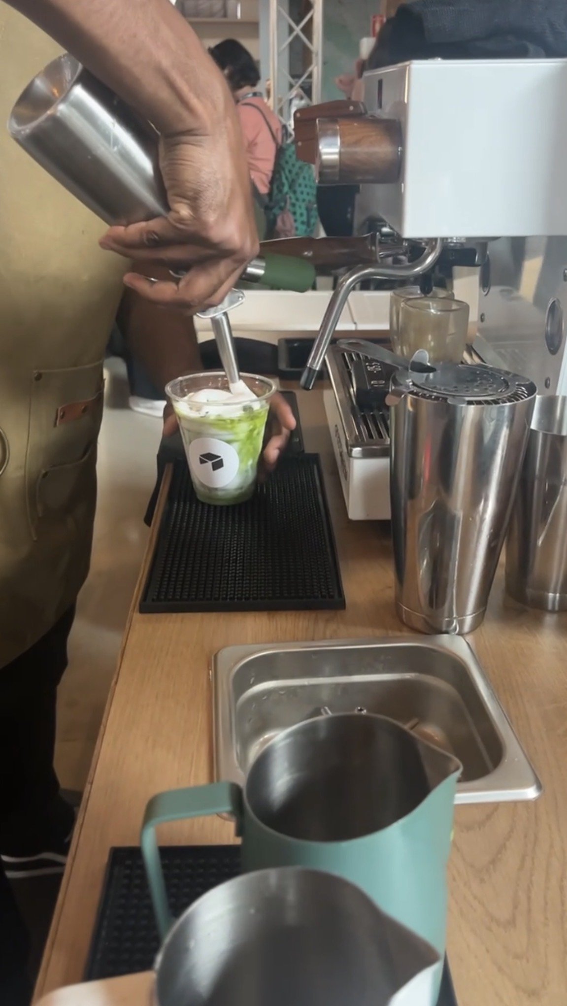 Pulo Coffee skilled barista preparing an iced matcha latte with cold foam at a mobile matcha bar event in Los Angeles