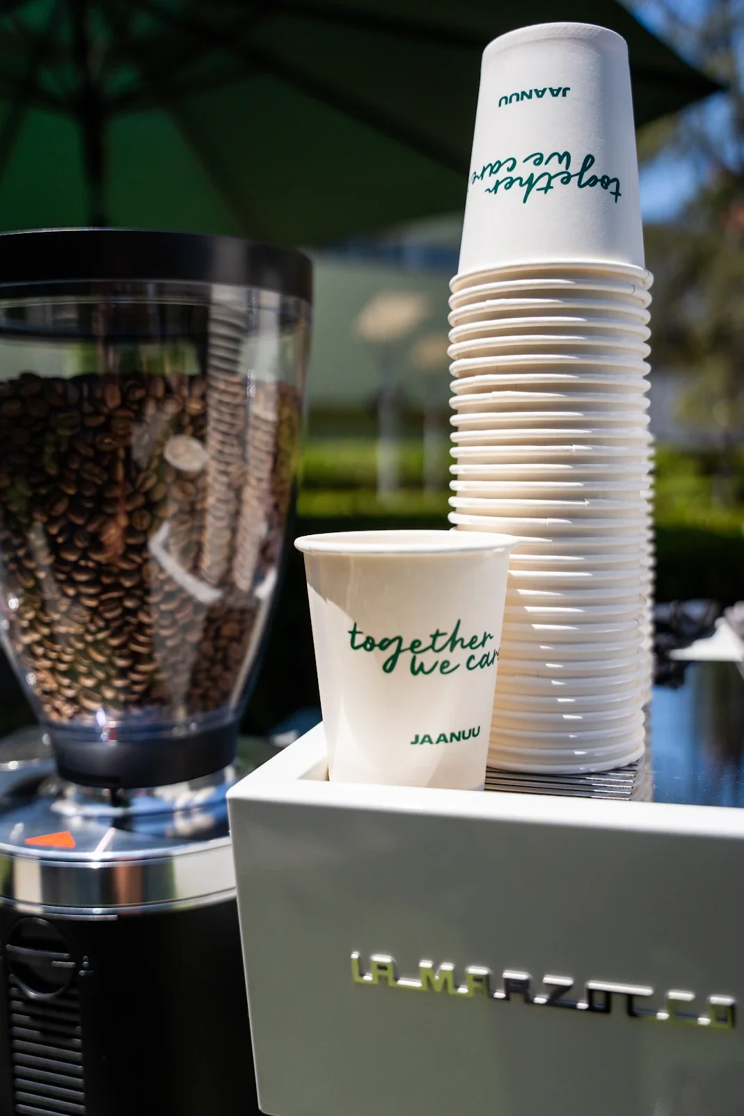 JAANUU branded coffee cups reading together we care at Pulo Coffee Nurses Week 2026 activation in Los Angeles