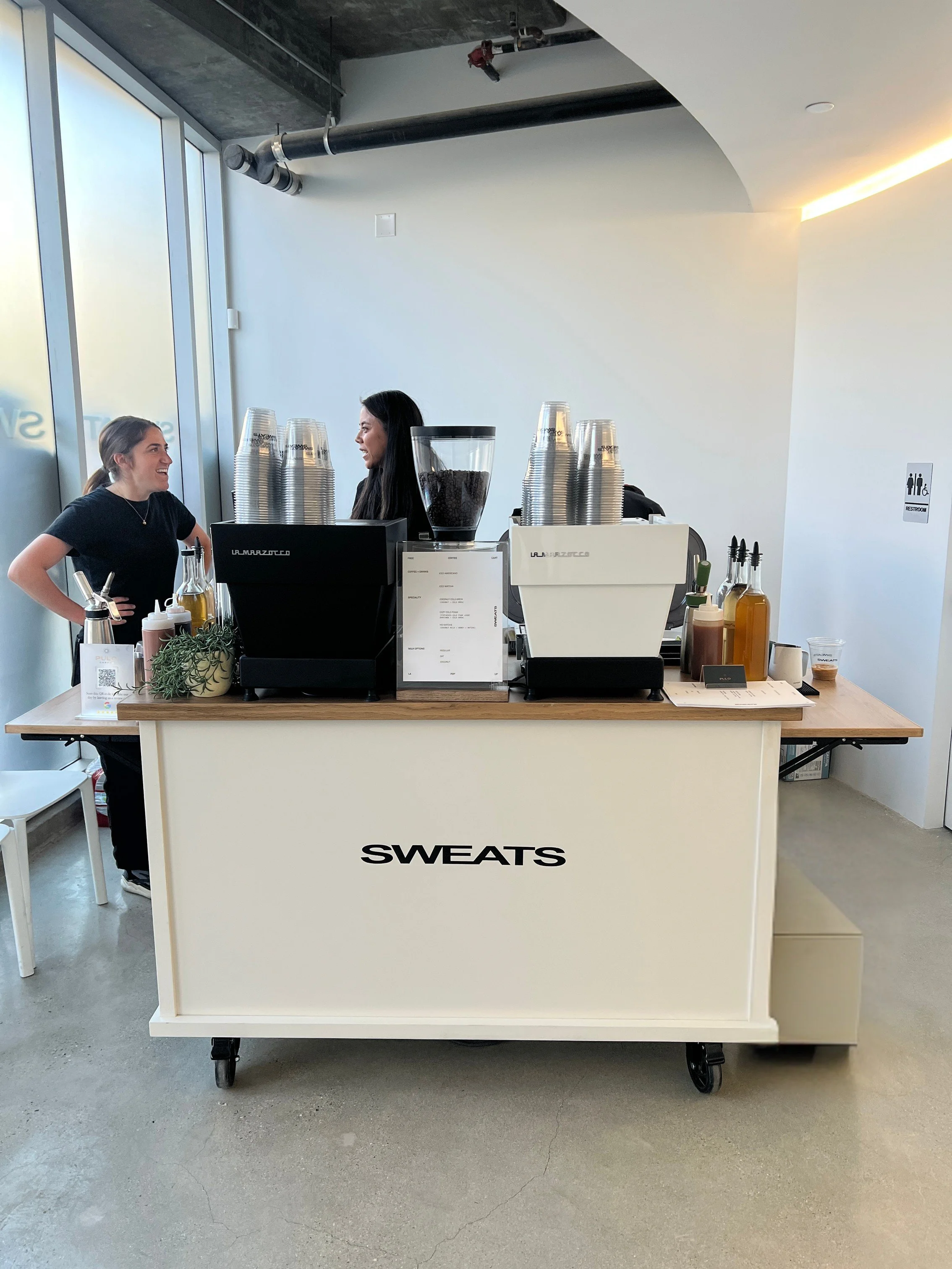 elevated coffee cart experience at a Los Angeles event with guests gathered around espresso bar