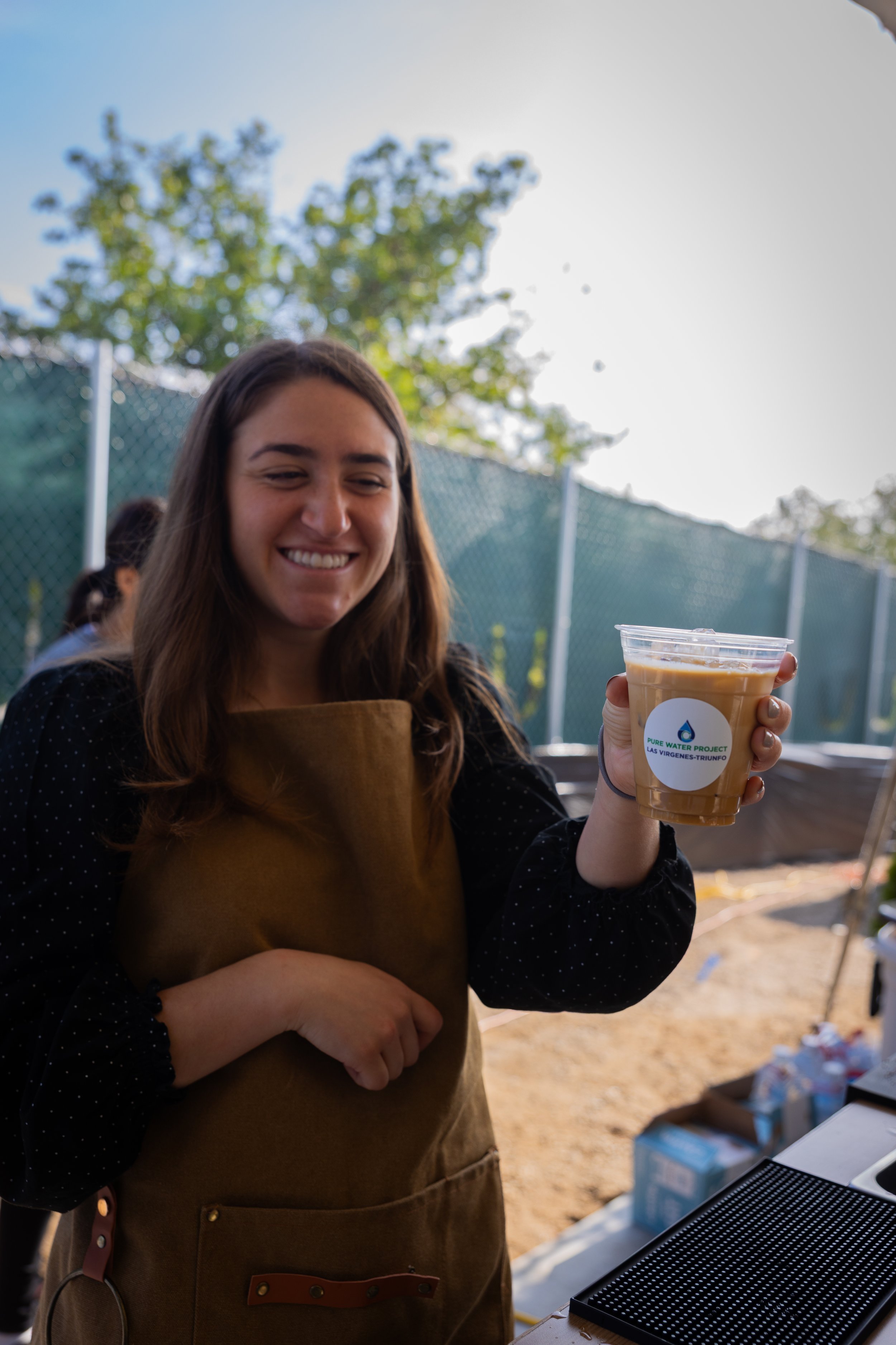Pulo Coffee barista serving branded iced coffee at outdoor Los Angeles corporate event