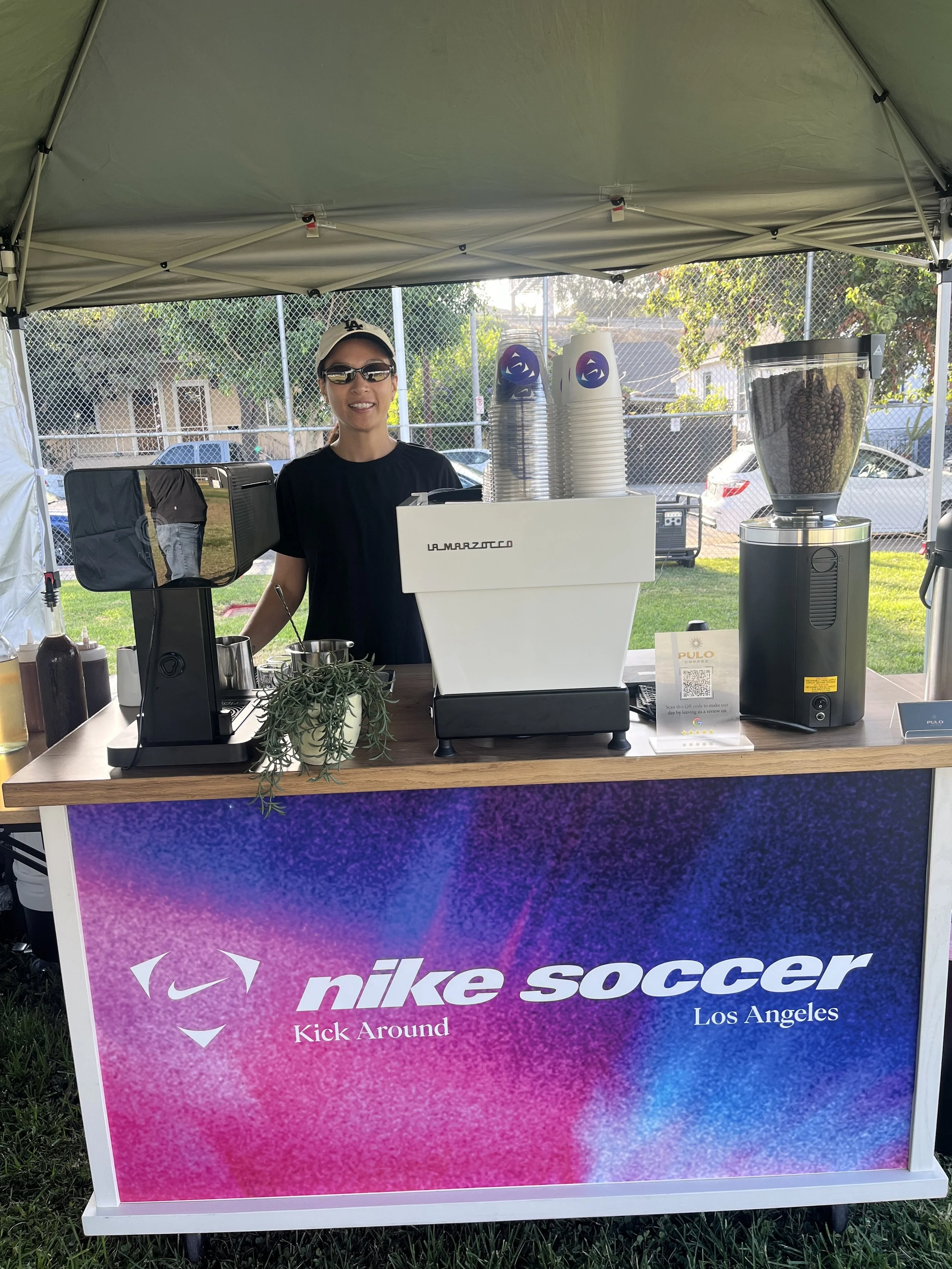 Pulo Coffee barista at Nike Soccer branded coffee cart at outdoor Los Angeles brand activation event