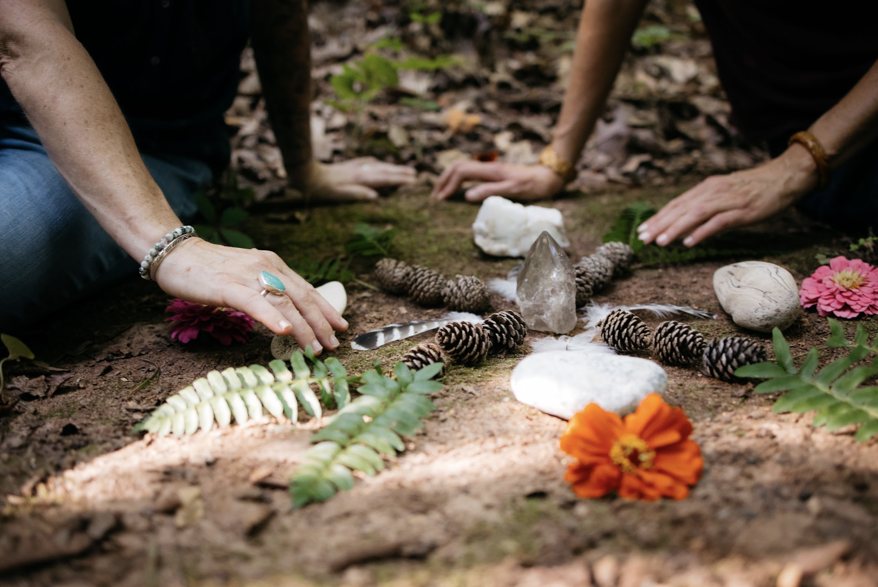 Instructors creating a mandala at forest therapy guide training