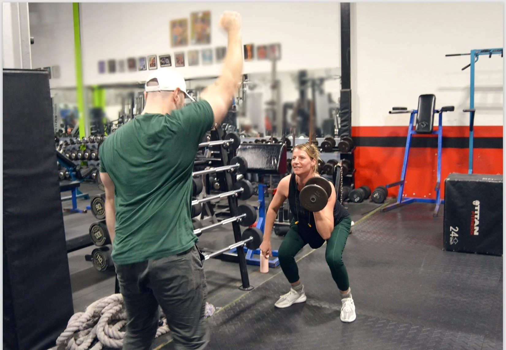 Client getting weight training from Dr. Zach Kaplan in a Gym setting