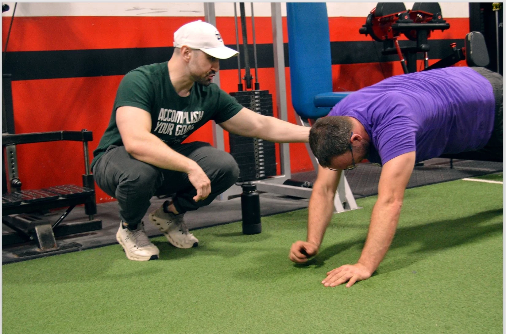 client is doing endurance exercise on the floor being guided by Dr. Zach Kaplan
