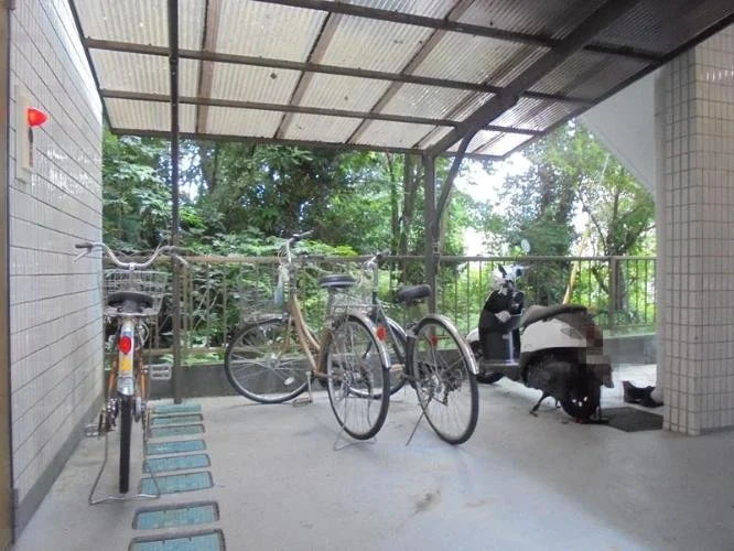自転車とバイクが駐輪されている屋根付きの駐輪場の様子